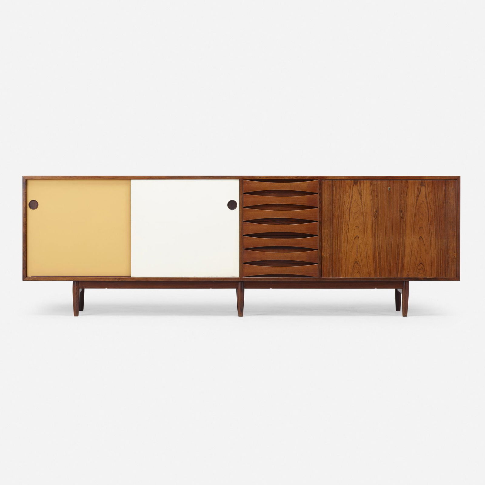 Arne Vodder, Credenza: Arne Vodder Credenza Sibast FurnitureDenmark, c. 1960rosewood, lacquered wood98.25 w × 18.5 d × 31.75 h in (250 × 47 × 81 cm) Credenza features two sliding doors con