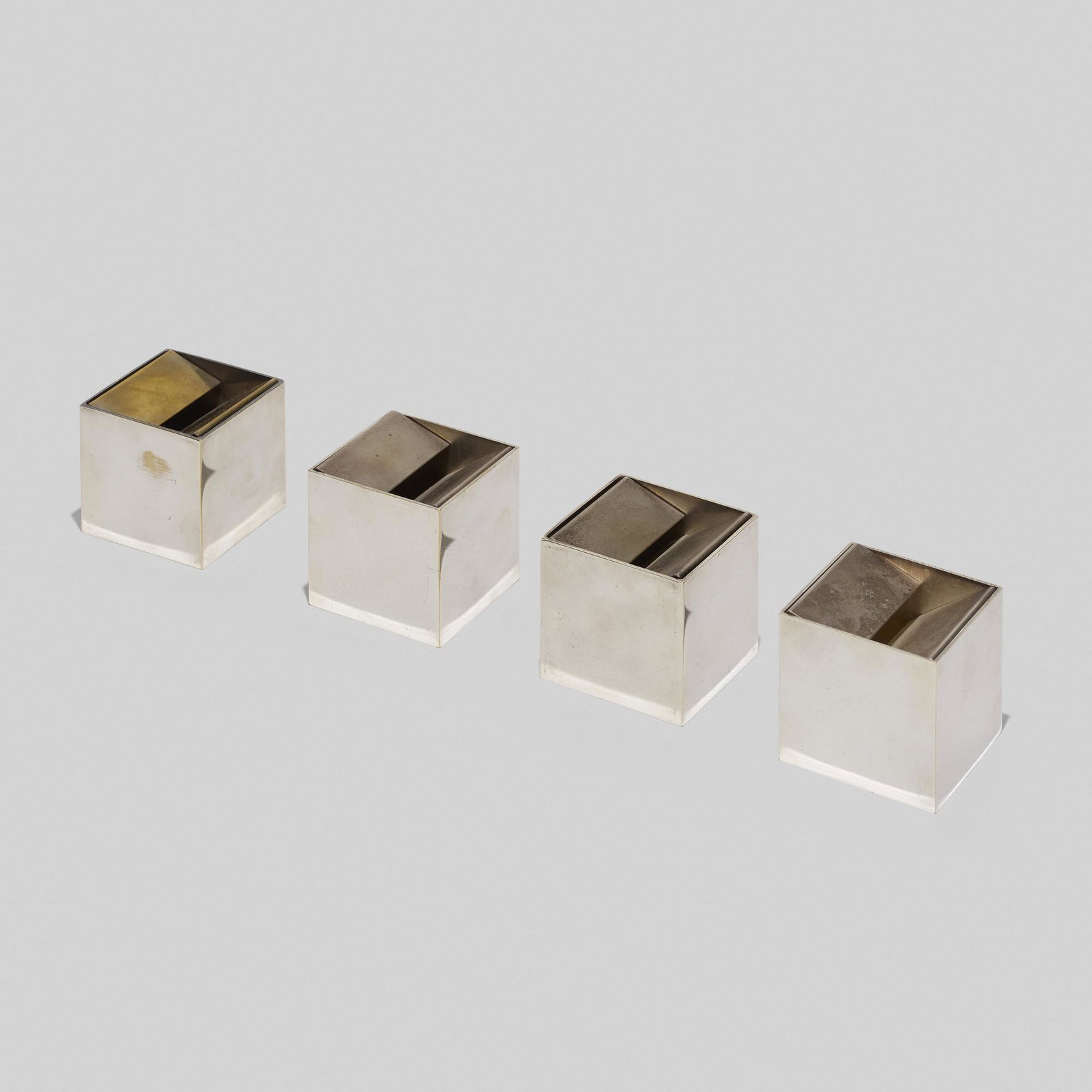 Bruno Munari, Cubo ashtrays model 2000A/A, set of four: Bruno Munari Cubo ashtrays model 2000A/A, set of four Danese Italy, 1957 silver-plated brass 2.25 h × 2.25 w × 2.25 d in (6 × 6 × 6 cm) Impressed manufacturer's mark to underside 'Copyright B.