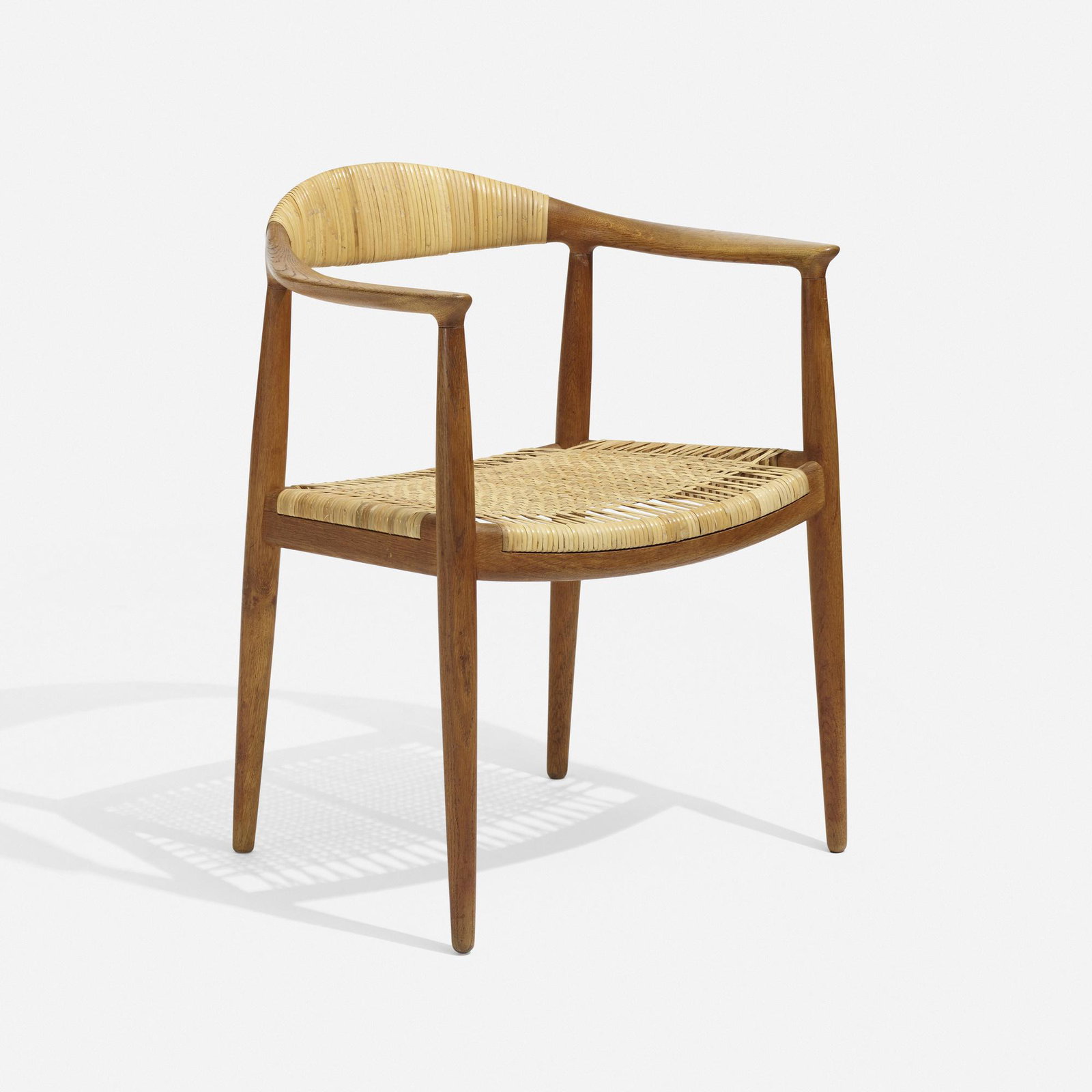 Hans J. Wegner, The Chair: Hans J. Wegner The Chair Johannes Hansen Denmark, 1949 oak, cane 30 h × 24.75 w × 20 d in (76 × 63 × 51 cm) Branded manufacturer's mark to underside 'Johannes Hanse
