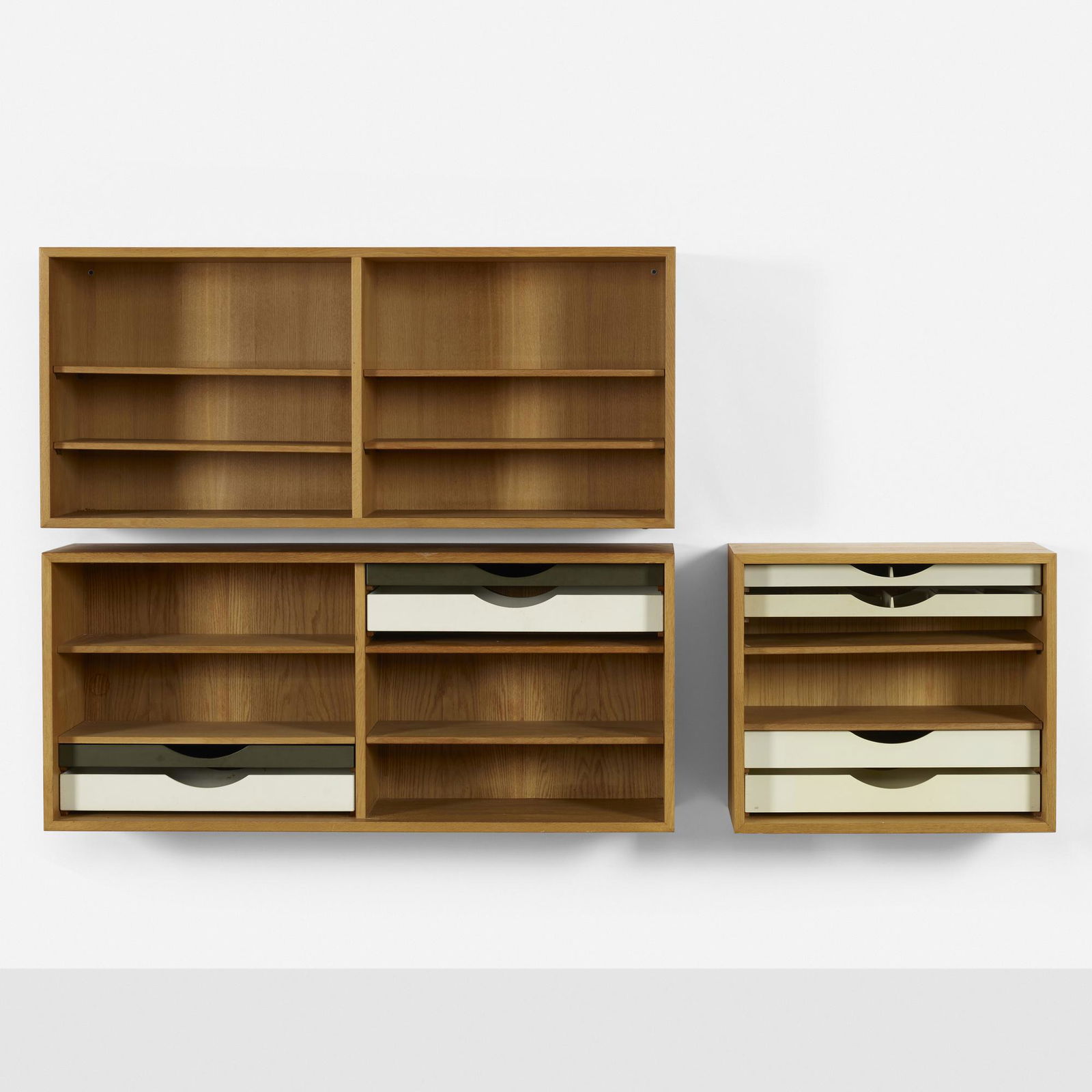 Borge Mogensen, Wall-mounted cabinets, set of three: Borge Mogensen Wall-mounted cabinets, set of three Karl Andersson & SonerDenmark / Sweden, c. 1955oak, lacquered wood 23.25 h × 53 w × 14.25 d in (59 × 135 × 36 cm) 2