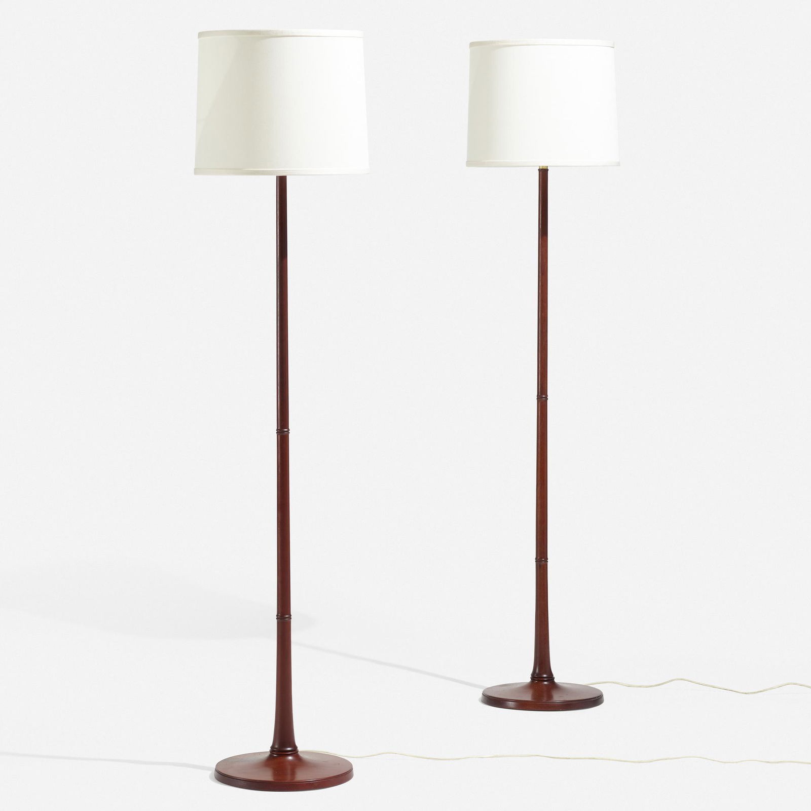 Kaare Klint, Le Klint floor lamps, pair: Kaare Klint Le Klint floor lamps, pair Le KlintDenmark, c. 1955mahogany, brass, linen shades 63.5 h × 15.25 dia in (161 × 39 cm) Applied decal manufacturer's label to undersi