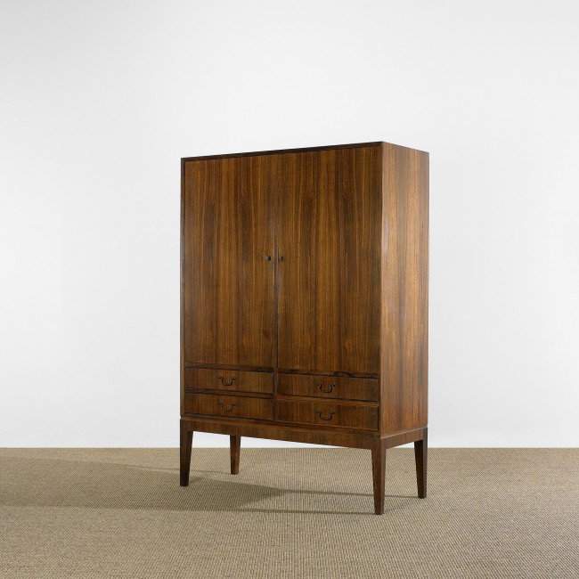 Ole Wanscher cabinet: Ole Wanscher cabinet A.J. Iversen Snedkermester Denmark, c. 1960 rosewood, brass 41.75 w x 17 d x 59.75 h inches Cabinet features four drawers beneath two doors concealing five adjustable shelves and 