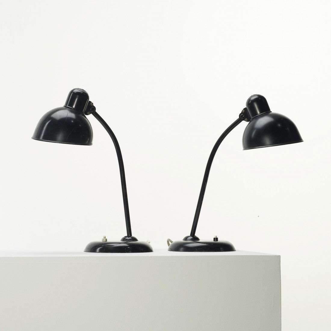 Christian Dell desk lamps, pair: Christian Dell desk lamps, pair Kaiser Germany, c. 1930 enameled steel 6 w x 14 d x 18 h inches Signed with molded manufacturer's mark to shade of each example: [Original Kaiser-Idell].