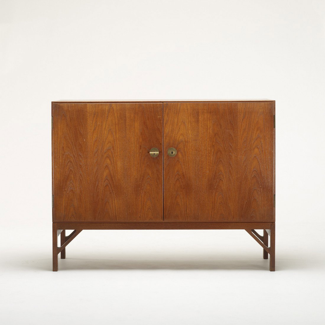 Børge Mogensen cabinet: Børge Mogensen cabinet Fredericia Stolefabrik Denmark, c. 1940 teak, brass 48 w x 18 d x 37 h inches Cabinet features two doors concealing two shelves and three drawers. Literature: Danish Modern, Ho
