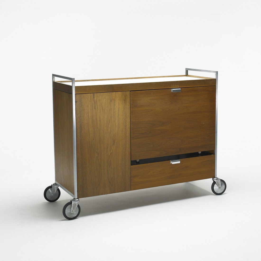 George Nelson & Associates bar cart: George Nelson & Associates bar cart Herman Miller USA, c. 1960 walnut, laminate, chrome-plated steel, aluminum, rubber 45 w x 21 d x 37.5 h inches Bar cart features one flip-door door concealing a Sea