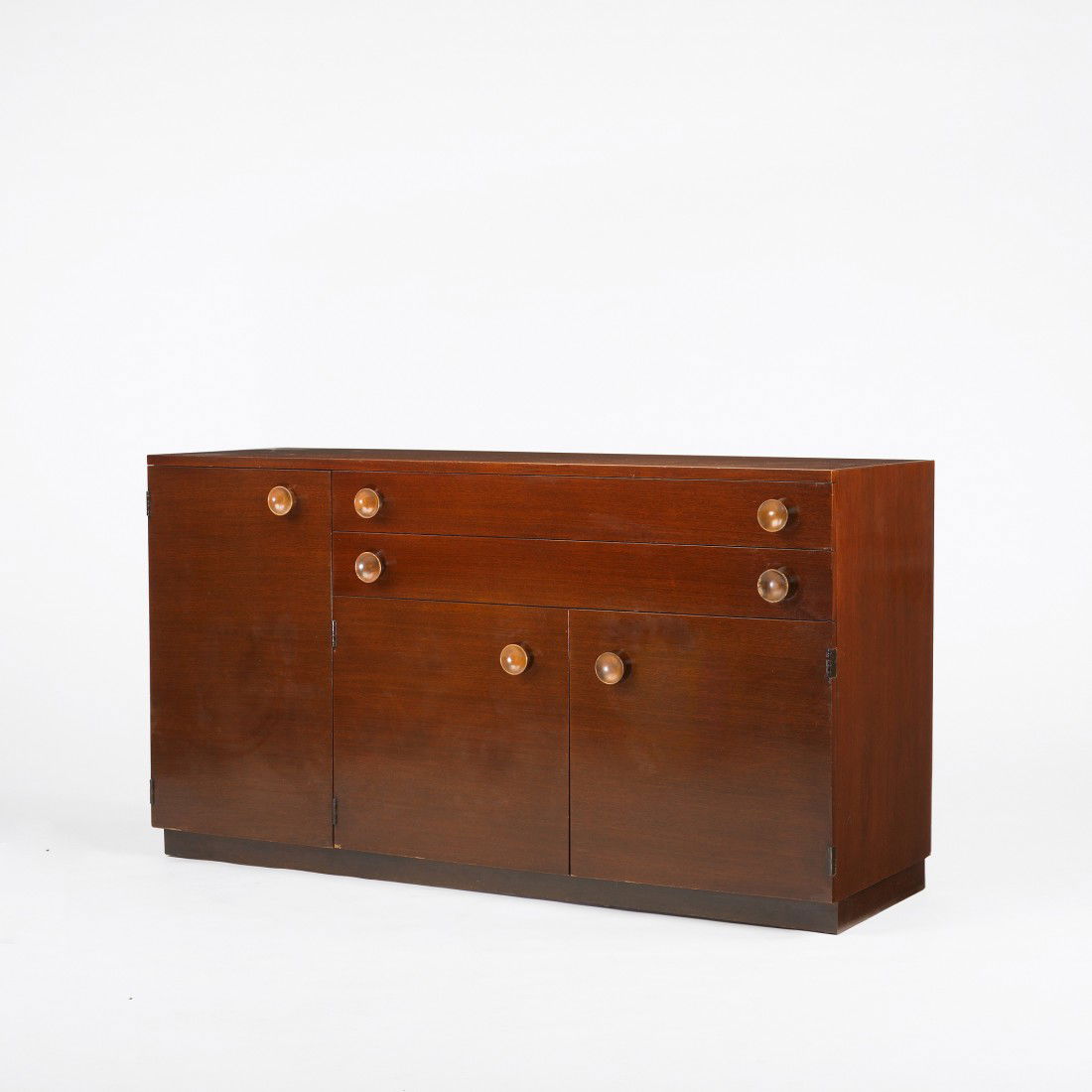 Gilbert Rohde cabinet: Gilbert Rohde cabinet Herman Miller USA, c. 1940 mahogany, stained beech 60 w x 22 d x 33.5 h inches Cabinet features two drawers, one door concealing four additional drawers and a pair of doors conce