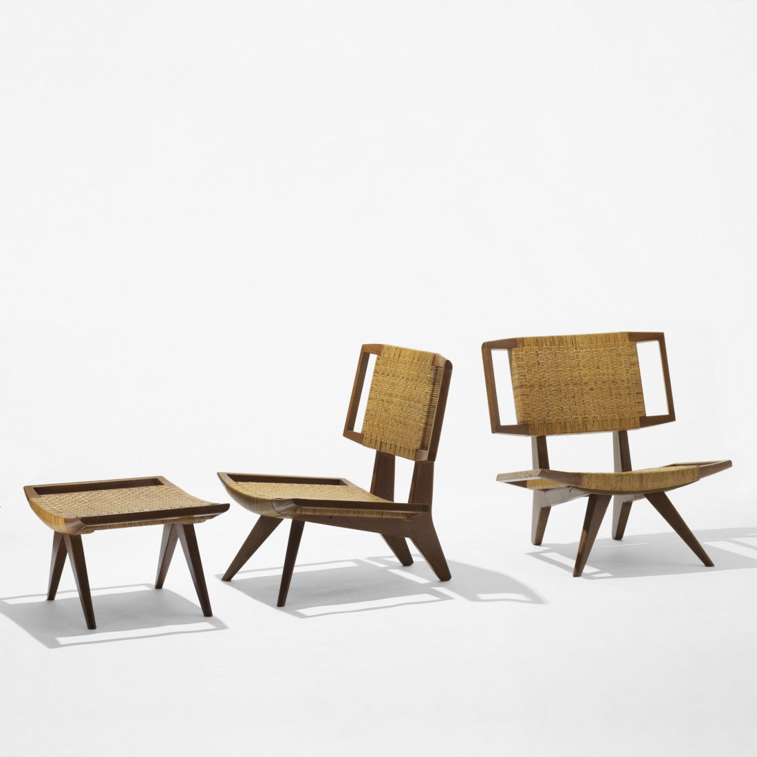 Paul Laszlo pair of lounge chairs and ottoman: Paul Laszlo pair of lounge chairs and ottoman Glenn Of California USA, 1950 walnut, cane 29 w x 27 d x 32 h inches Ottoman measures: 29 w x 21 d x 15 h inches.