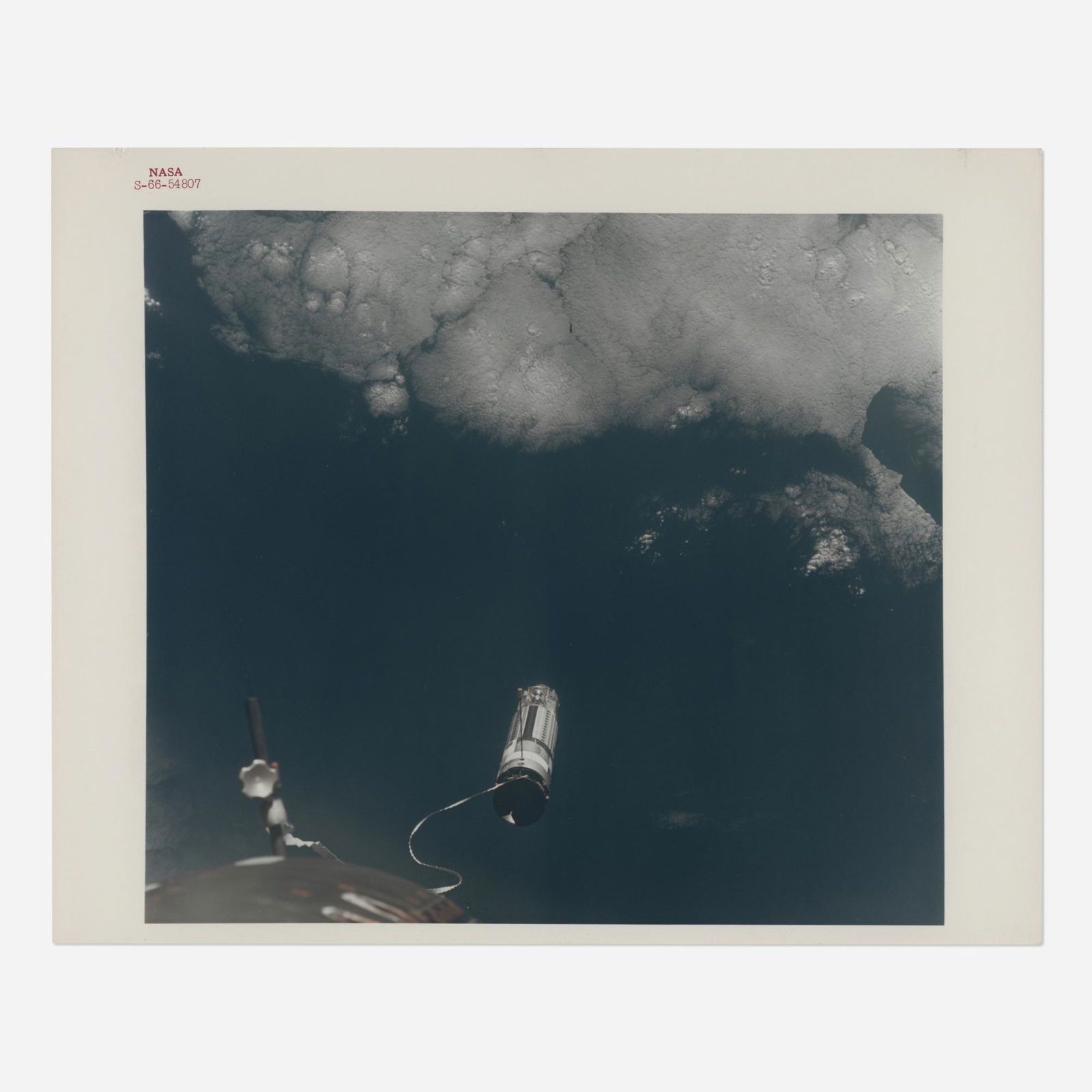 Agena tethered to the spacecraft over the Earth (1 of 3)