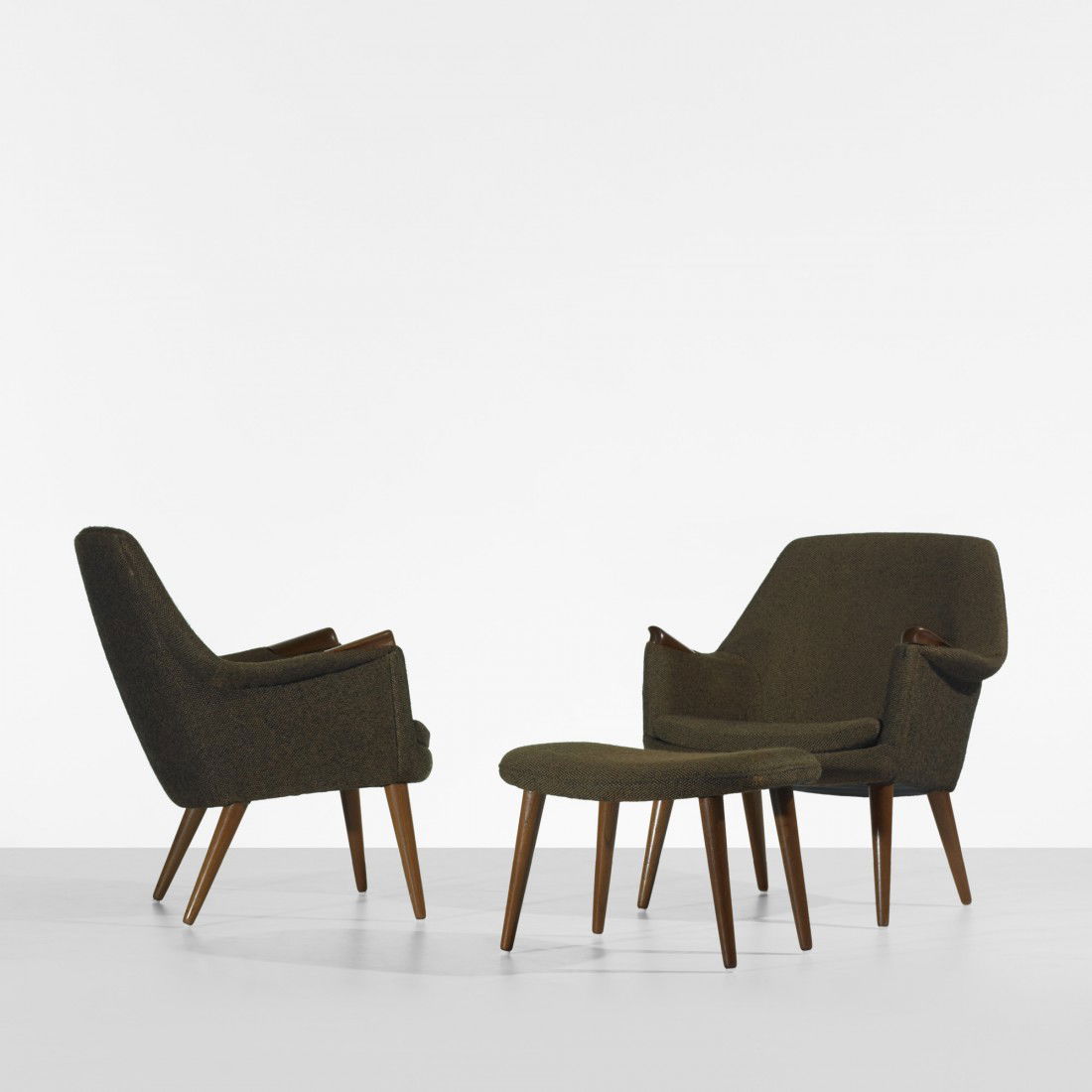 In the manner of Hans Wegner chairs with ottoman: In the manner of Hans Wegner pair of lounge chairs with ottoman c. 1960 upholstery, teak 29 w x 29 d x 33 h inches Ottoman measures: 22.75 w x 16.75 d x 15.5 h inches.