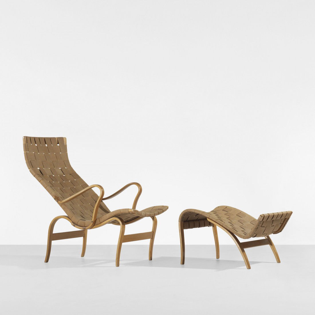 Bruno Mathsson Pernilla chair and ottoman: Bruno Mathsson Pernilla chair and ottoman Karl Mathsson Sweden, 1941/1943 laminated steam-bent beech, canvas 25.5 w x 39 d x 36.5 h inches Ottoman measures: 20 w x 26 d x 16 h inches. Signed with appl