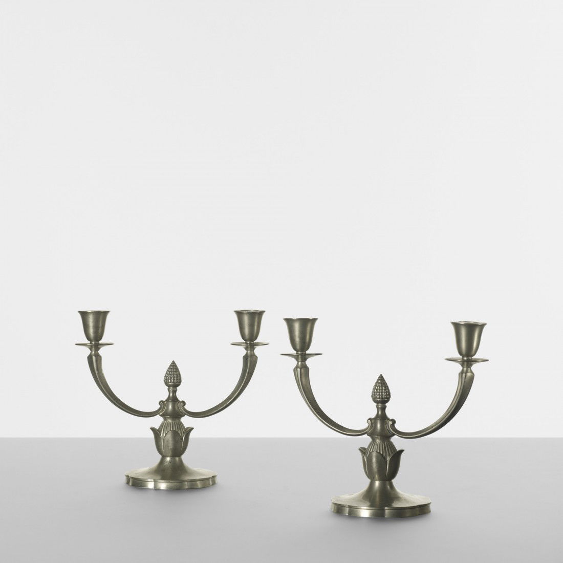 Just Andersen candlesticks, pair: Just Andersen candlesticks, pair Guldsmeds Aktiebolaget Denmark, c. 1940 cast pewter 9 w x 4 d x 7.75 h inches Signed with cast manufacturer's mark to underside of each example: [Just 1238].