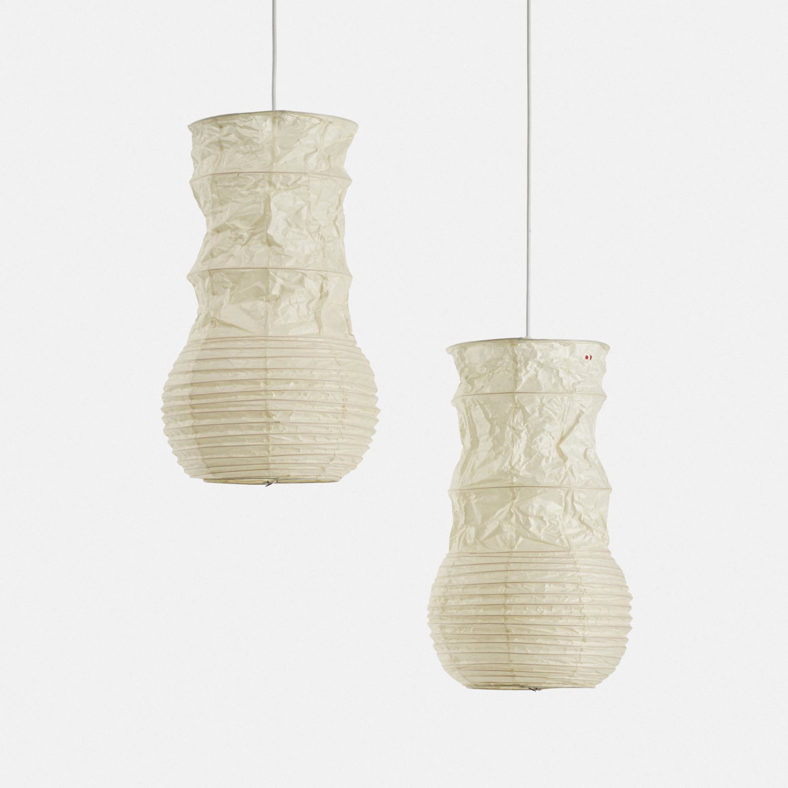 Isamu Noguchi, Akari light sculptures, pair: Isamu Noguchi Akari light sculptures model S1, pair Ozeki & Co., Ltd. Japan designed by 1977 washi paper, bamboo 21 h x 11.5 dia in (53 x 29 cm) Stamped 'Sun and Moon' ideogram to each sha