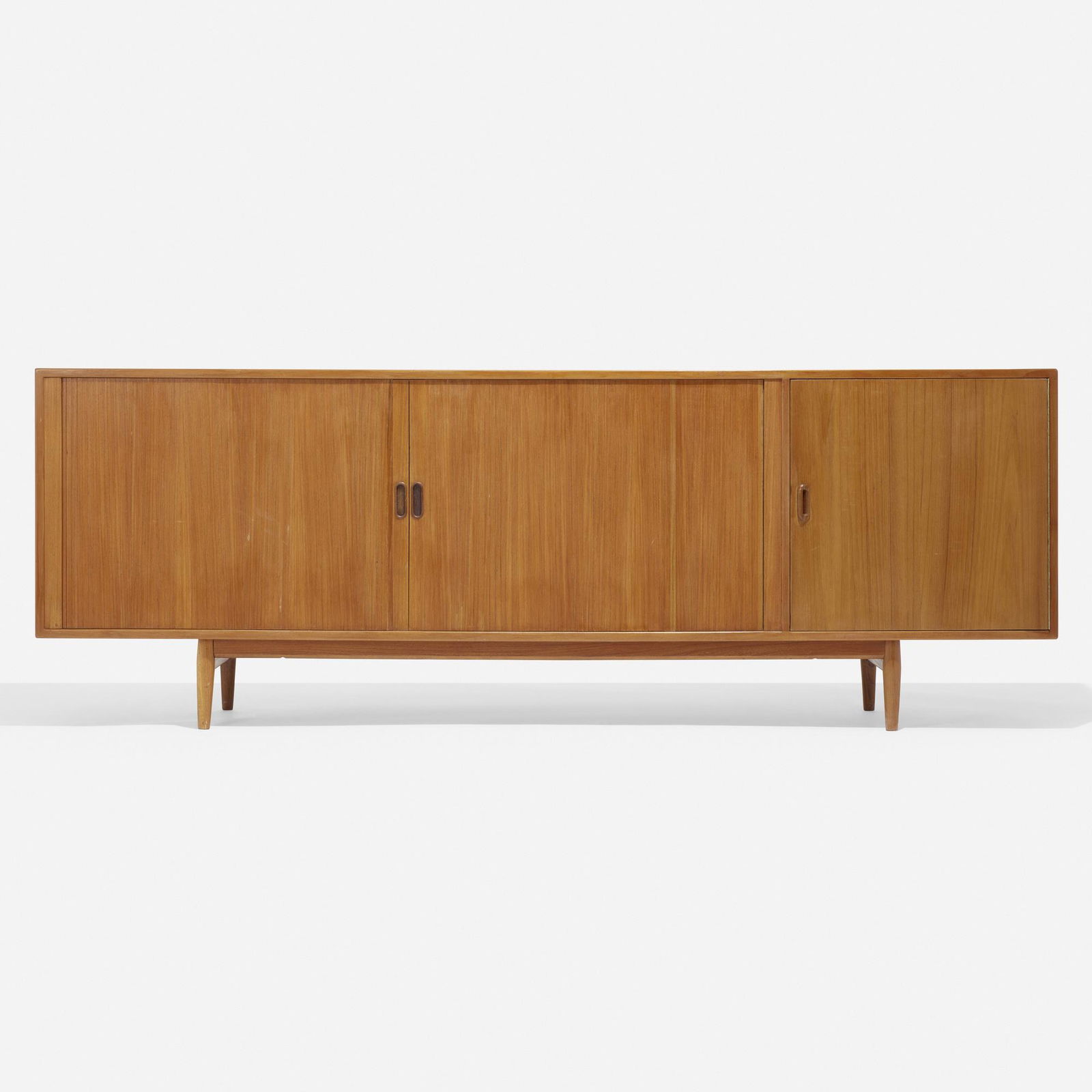 Arne Vodder, Cabinet: Arne Vodder Cabinet Sibast MoblerDenmark, c. 1965teak 31.5 h x 89 w x 18.5 d in (80 x 226 x 47 cm) Cabinet features two tambour doors concealing six removable trays and four adjustable s
