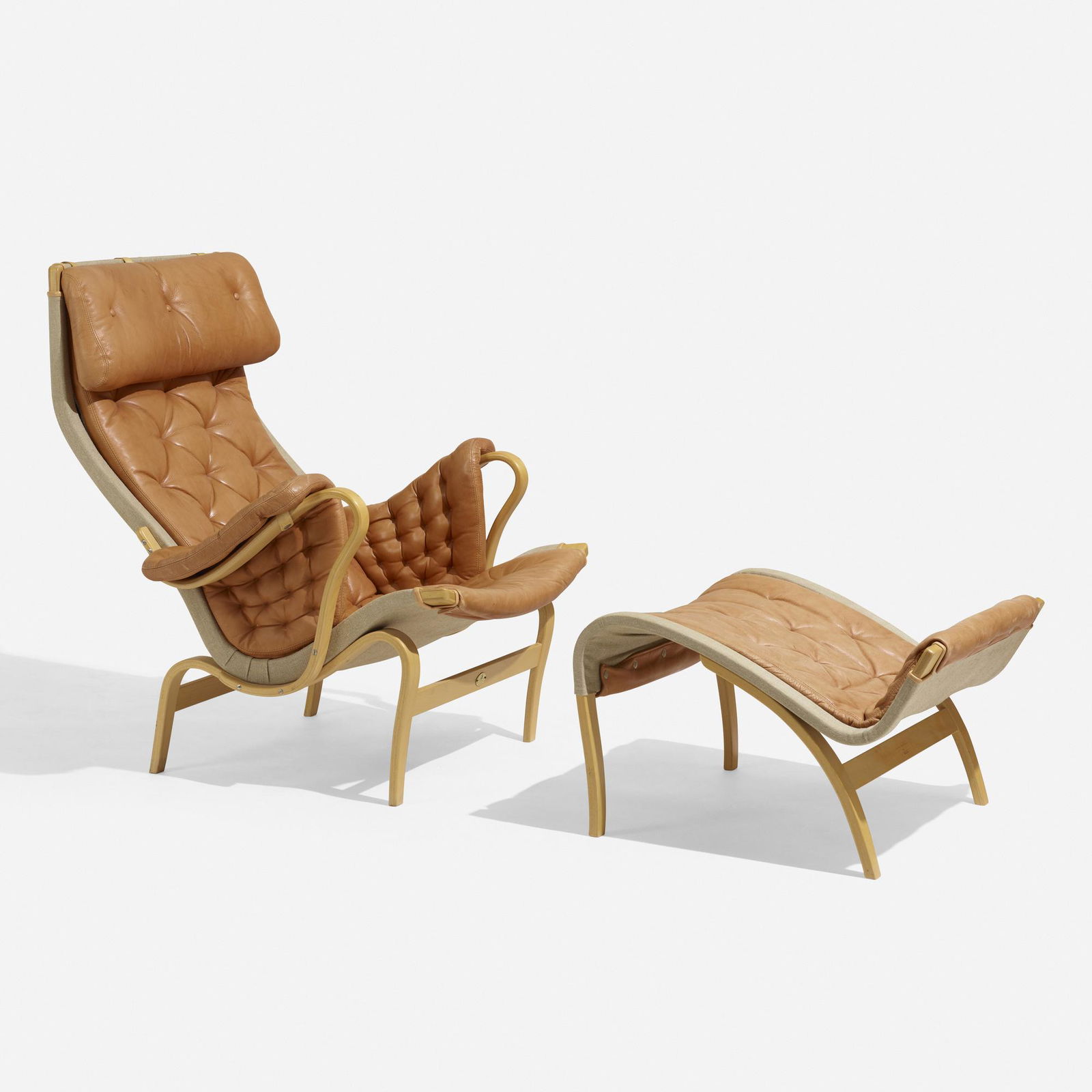 Mathsson, Pernilla 69 lounge chair and ottoman: Bruno Mathsson Pernilla 69 lounge chair and ottoman DUXSweden, 1969 / 1994leather, beech plywood, canvas chair: 38.25 h x 35 w x 37 d in (97 x 89 x 94 cm) ottoman: 16 h x 24.5 w x 28 d in (4