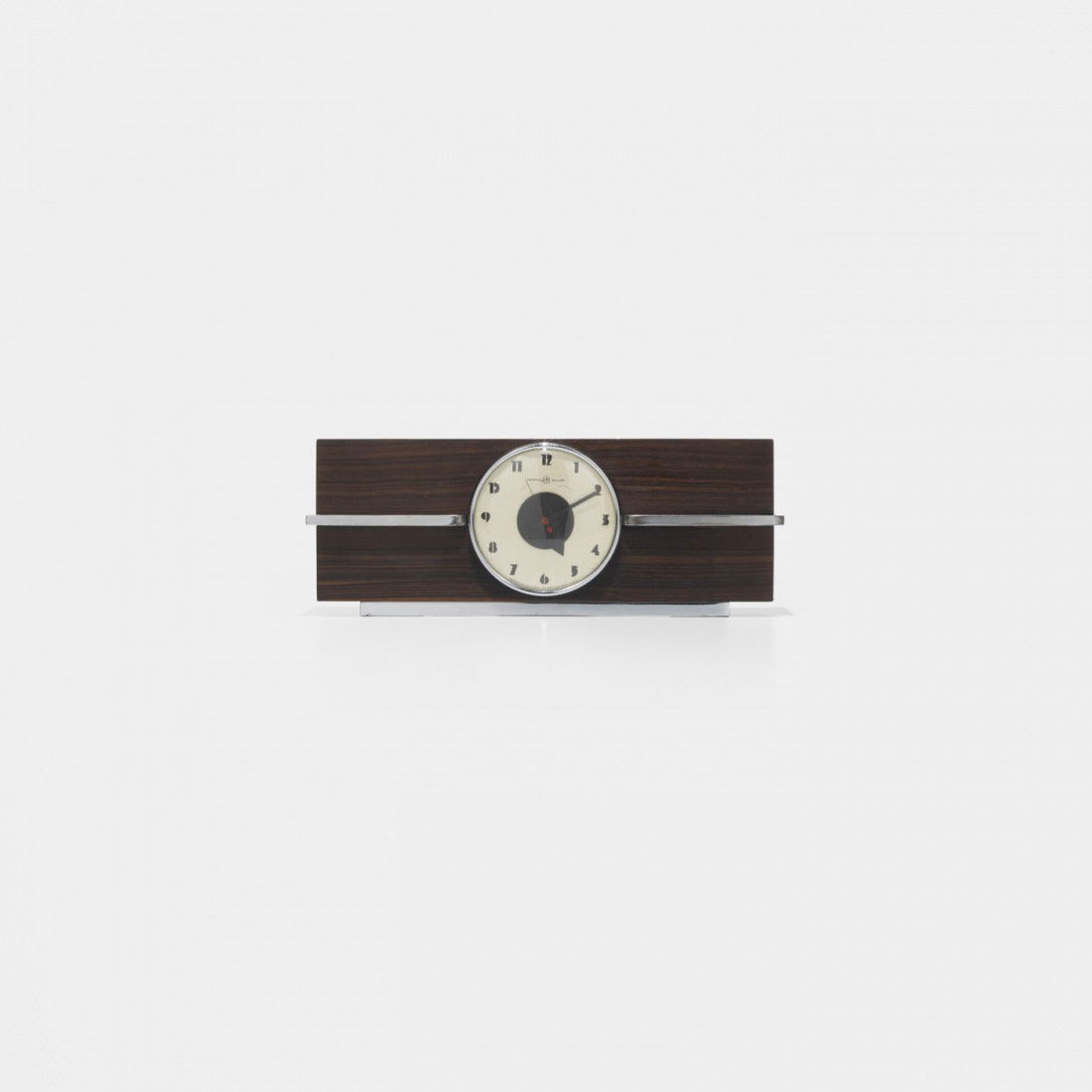 Gilbert Rohde table clock, model 6366: Gilbert Rohde table clock, model 6366 Herman Miller Clock Company USA, c. 1932 macassar ebony, chrome-plated steel, enameled aluminum, glass 16.75 w x 3.25 d x 6.25 h inches Signed with printed manufa