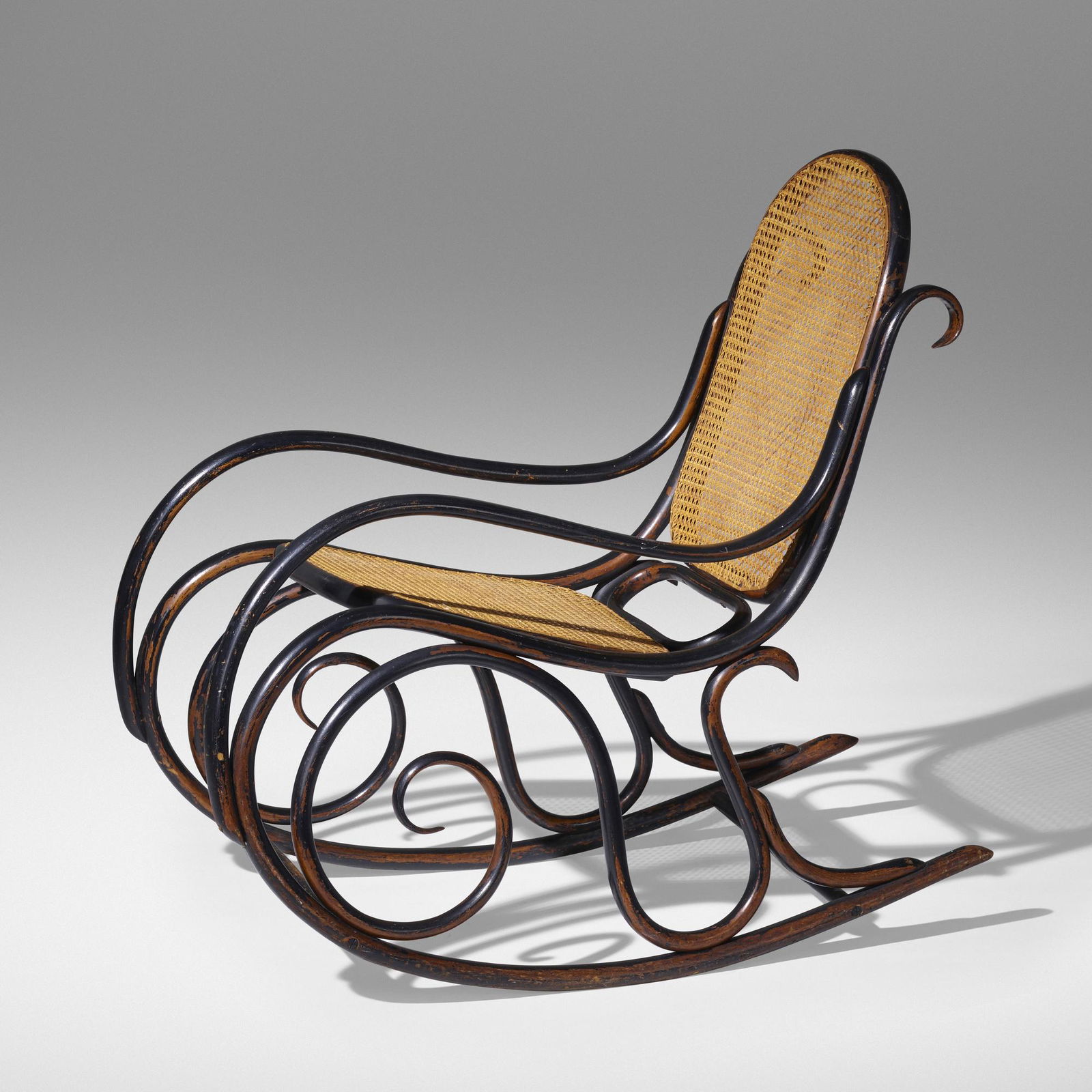 Gebruder Thonet, Rocking chair: Gebruder Thonet Rocking chair, model 10 from the collection of Paul Rand Austria, c. 1904painted beech, hand-woven cane 35 h x 22 w x 37 d in (89 x 56 x 94 cm) Provenance: The