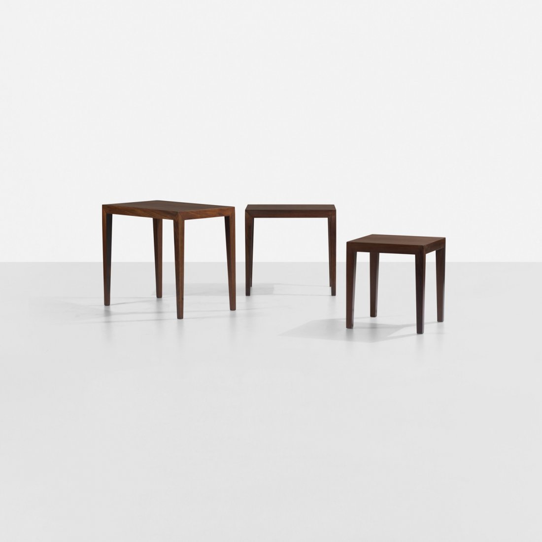 Ole Wanscher nesting tables, set of three: Ole Wanscher nesting tables, set of three Haslev Møbelsnedkeri A/S Denmark, c. 1965 rosewood 23 w x 13.75 d x 19.75 h inches Signed with paper manufacturer's label to underside of smallest example: [