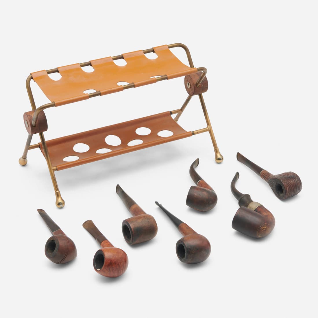 Henry P. Glass, Collection of pipes and pipe rest: Henry P. Glass Collection of pipes and pipe rest USA, c. 1955brass, leather, walnut, carved wood, silver-plated brass stand: 6.5 h x 11.5 w x 6 d in (17 x 29 x 15 cm) largest pipe: 4.25 h x 1.25 d