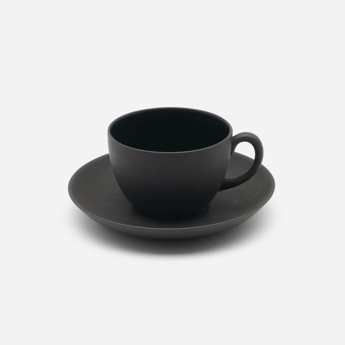 Wedgwood, Black Basalt cup and saucer: Wedgwood Black Basalt cup and saucer United Kingdom, c. 1908 glazed porcelain cup: 2.25 h x 4.125 w x 3.25 d in (6 x 10 x 8 cm) saucer: .75 h x 5.5 dia in (2 x 14 cm) Impressed manufacturer'