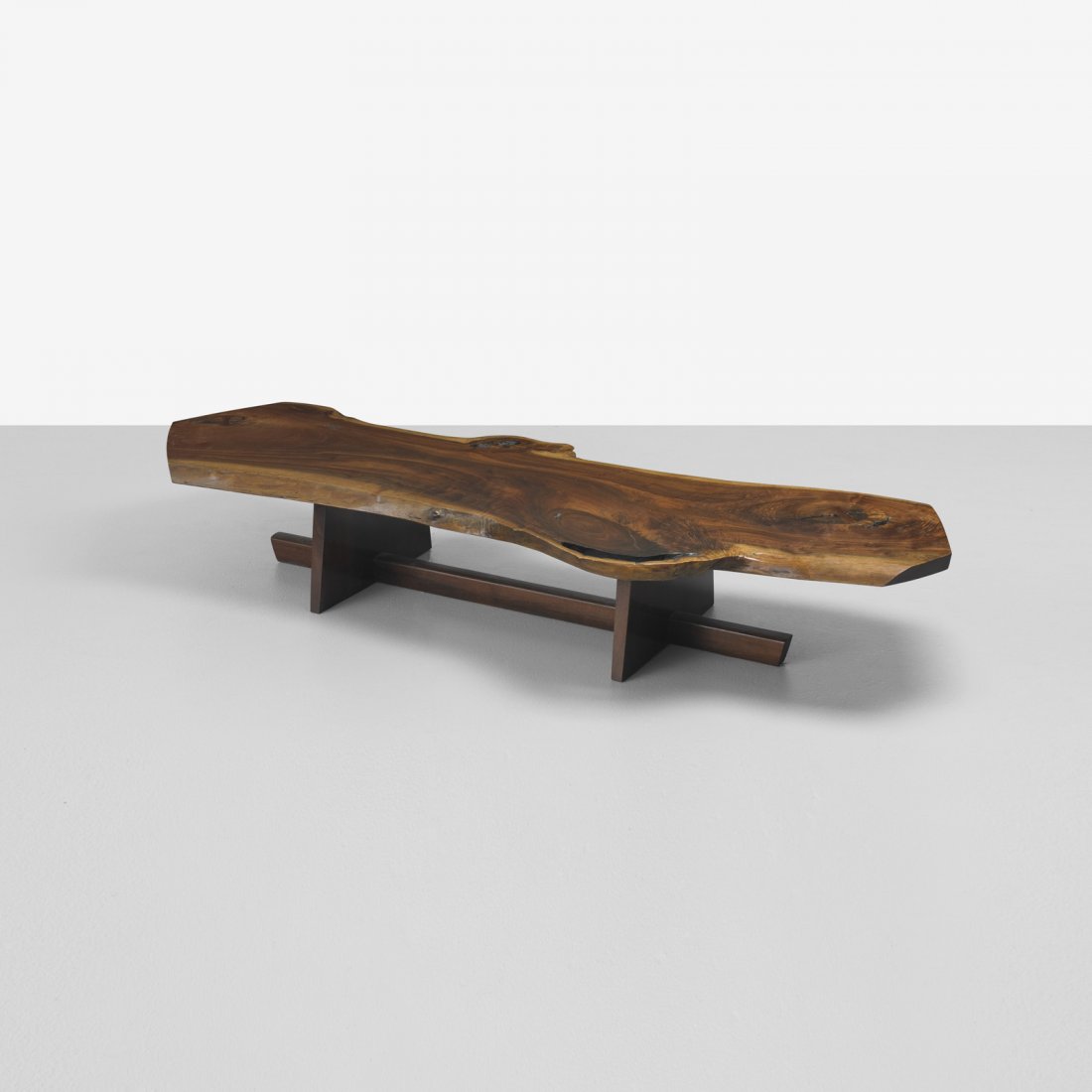 George Nakashima monumental Minguren I coffee tabl: George Nakashima monumental Minguren I coffee table USA, 1977 American black walnut, East Indian rosewood 98.5 w x 34.5 d x 15.5 h inches Thick-cut single slab top with two free edges, fissures, two r