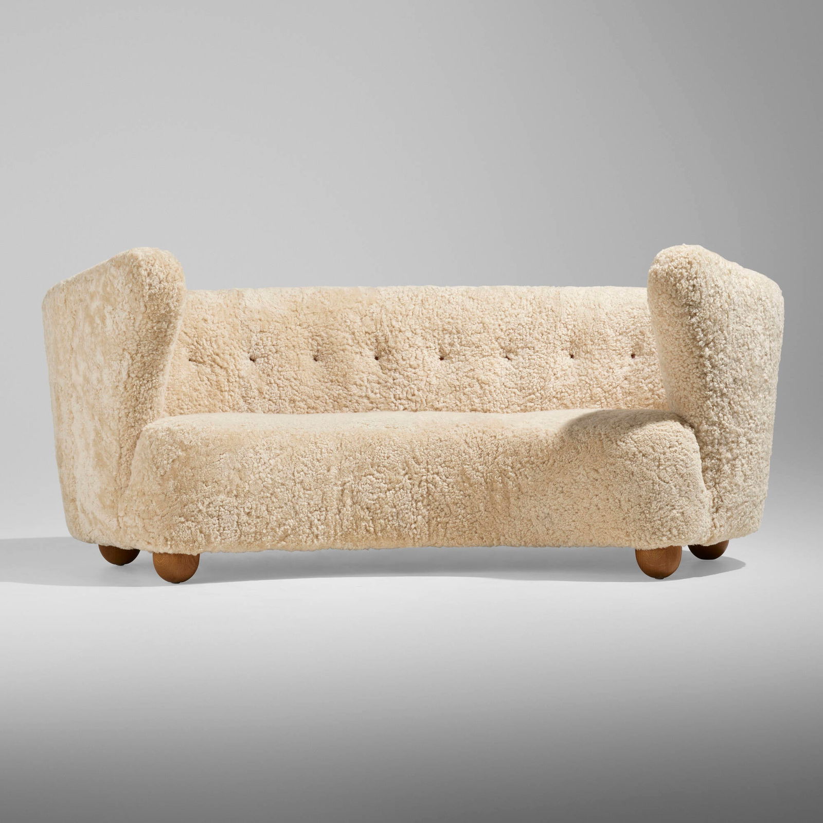 Flemming Lassen, attribution, Sofa: Flemming Lassen, attribution Sofa Denmark, c. 1940sheepskin, leather, oak 33 h x 77 w x 41 d in (84 x 196 x 104 cm) This work will ship from Lambertville, New Jersey.