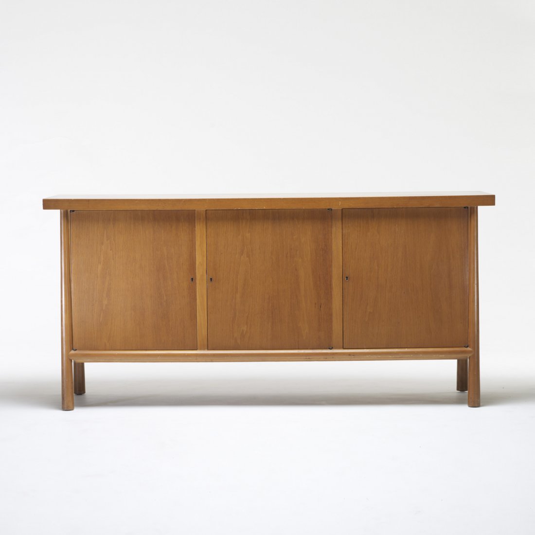 T.H. Robsjohn-Gibbings cabinet: T.H. Robsjohn-Gibbings cabinet Widdicomb United Kingdom, c. 1960 bleached walnut 72 w x 20 d x 34 h inches Cabinet features three doors concealing fours drawers and two adjustable shelves. Signed with
