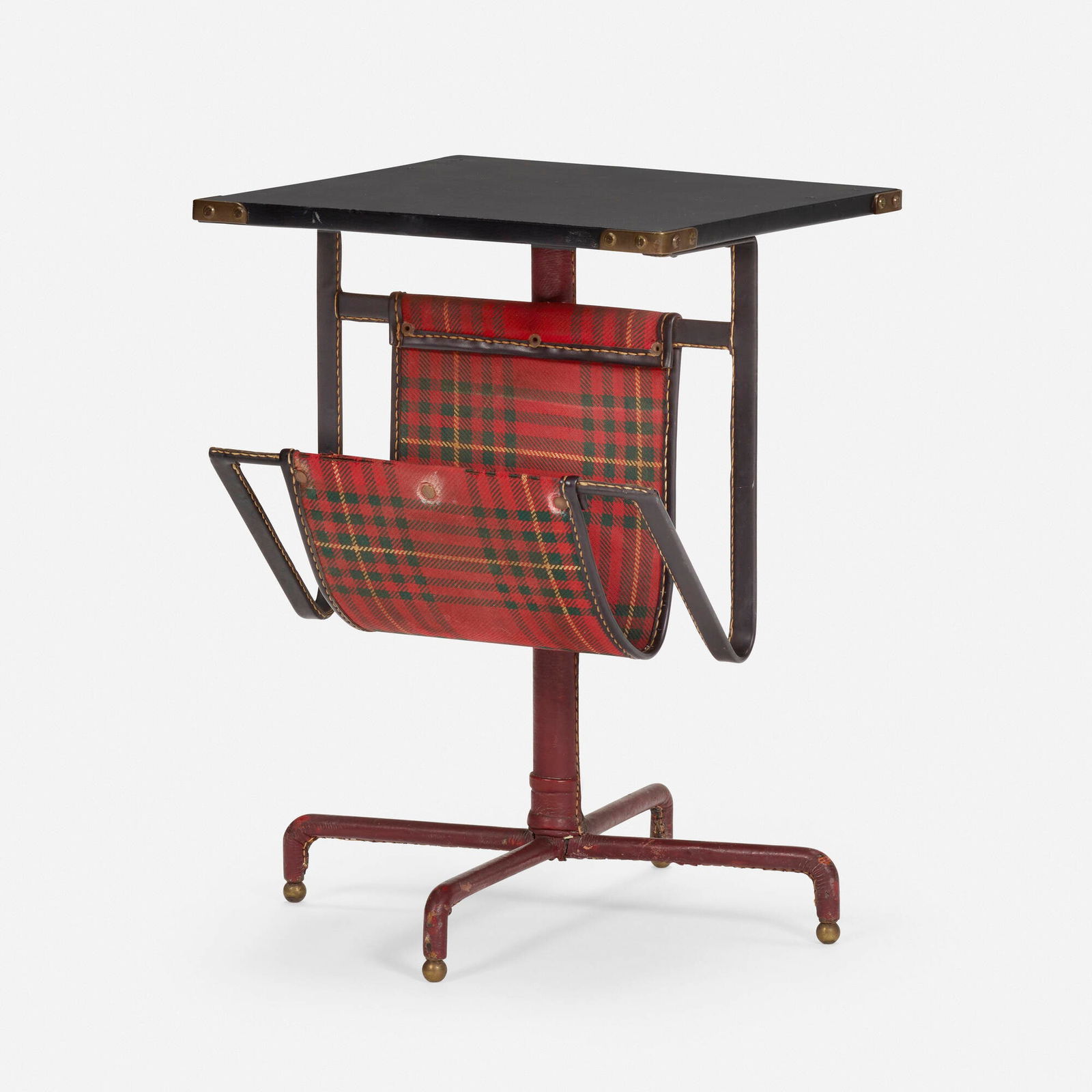 In the manner of Jacques Adnet, Occasional table: In the manner of Jacques Adnet Occasional table c. 1955saddle-stitched leather over iron and wood, brass, upholstery 21 h x 15 w x 15 d in (53 x 38 x 38 cm) Table features a magazine rack and