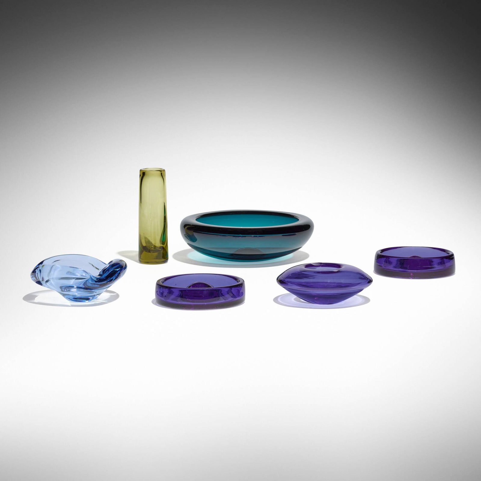 Holmegaard, Collection of six tabletop articles: Holmegaard Collection of six tabletop articles Denmark, c. 1955glass largest: 3.125 h x 10 dia in (8 x 25 cm) smallest: 6.825 h x 2.25 dia in (17 x 6 cm) Collection is comprised of five bow