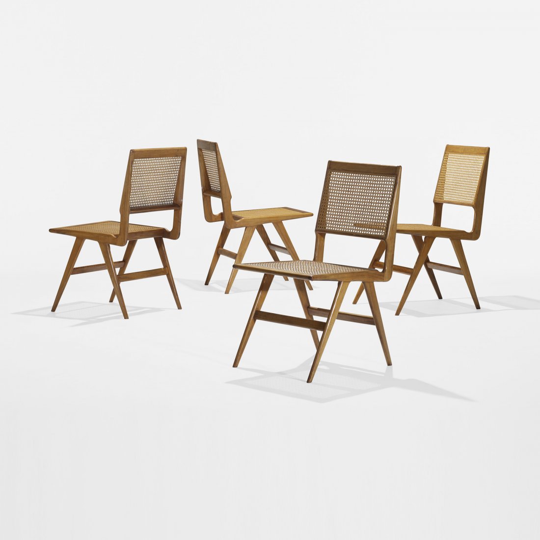 Martin Eisler and Carlo Hauner dining chairs: Martin Eisler and Carlo Hauner dining chairs, set of four Forma Moveis Italy/Austria, c. 1960 teak, caning 17.75 w x 20 d x 32.5 h inches Signed with applied manufacturer's label to underside of each