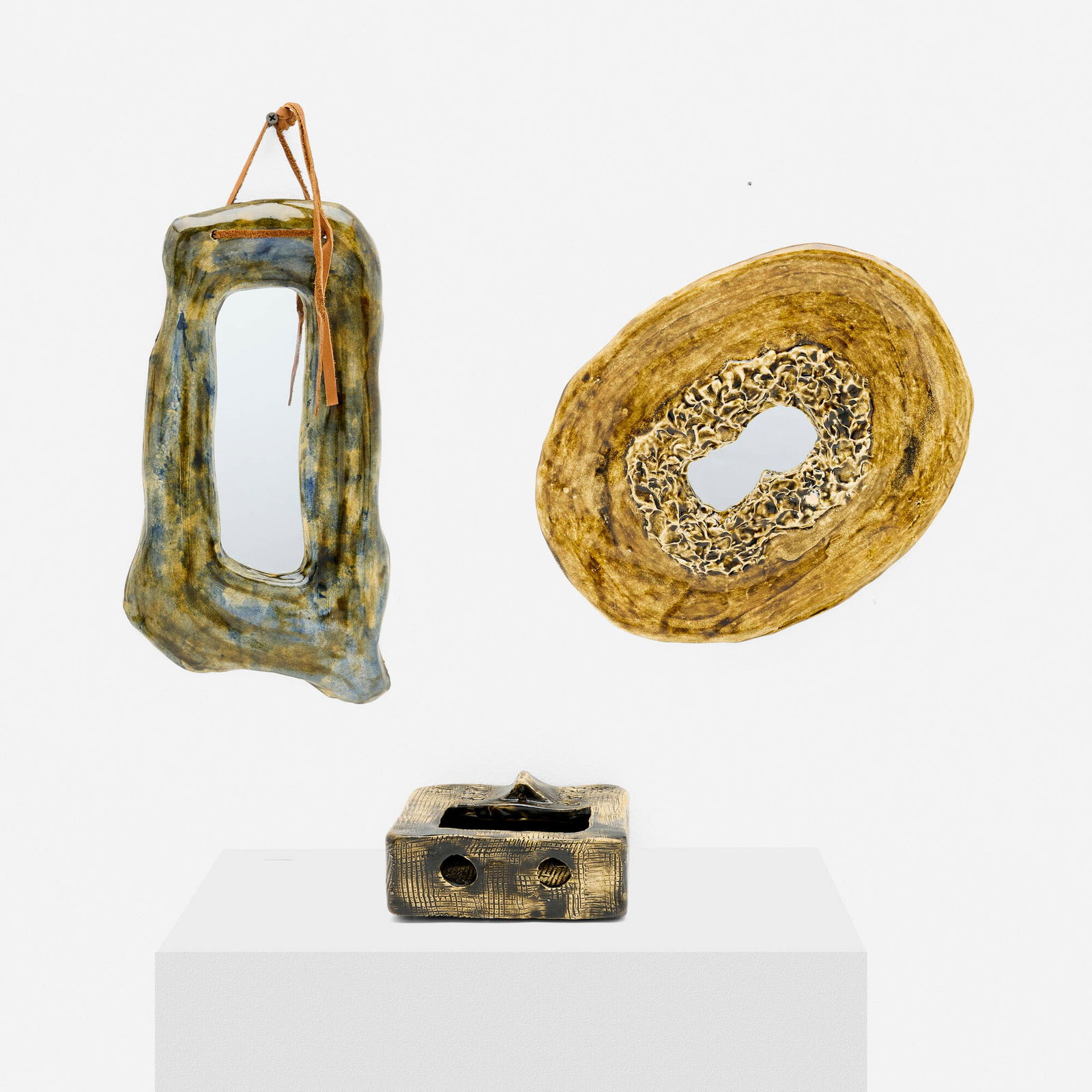 Juliette Derel, Collection of three works: Juliette Derel Collection of three works France, c. 1955glazed ceramic, mirrored glass, leather 13.5 h x 7 w x .75 d in (34 x 18 x 2 cm) 12 h x 9.25 w x 1 d in (30 x 23 x 3 cm) 2.625 h x 5.5 w