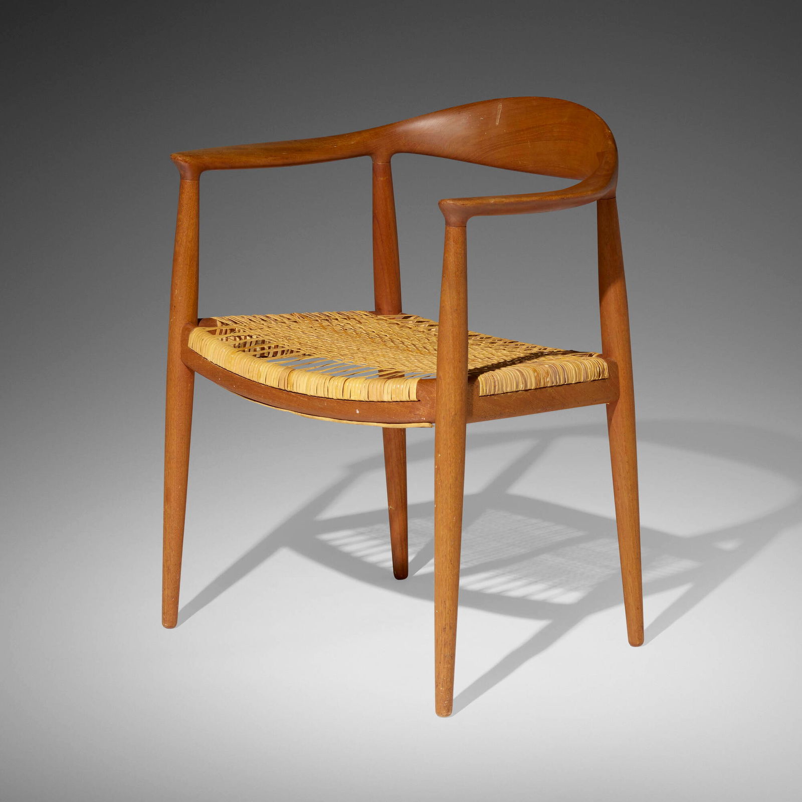 Hans J. Wegner, The Chair: Hans J. Wegner The Chair Johannes Hansen for Knoll InternationalDenmark, 1949 / c. 1975teak, cane 29.75 h x 24.75 w x 20 d in (76 x 63 x 51 cm) Decal manufacturer's label to underside 'M