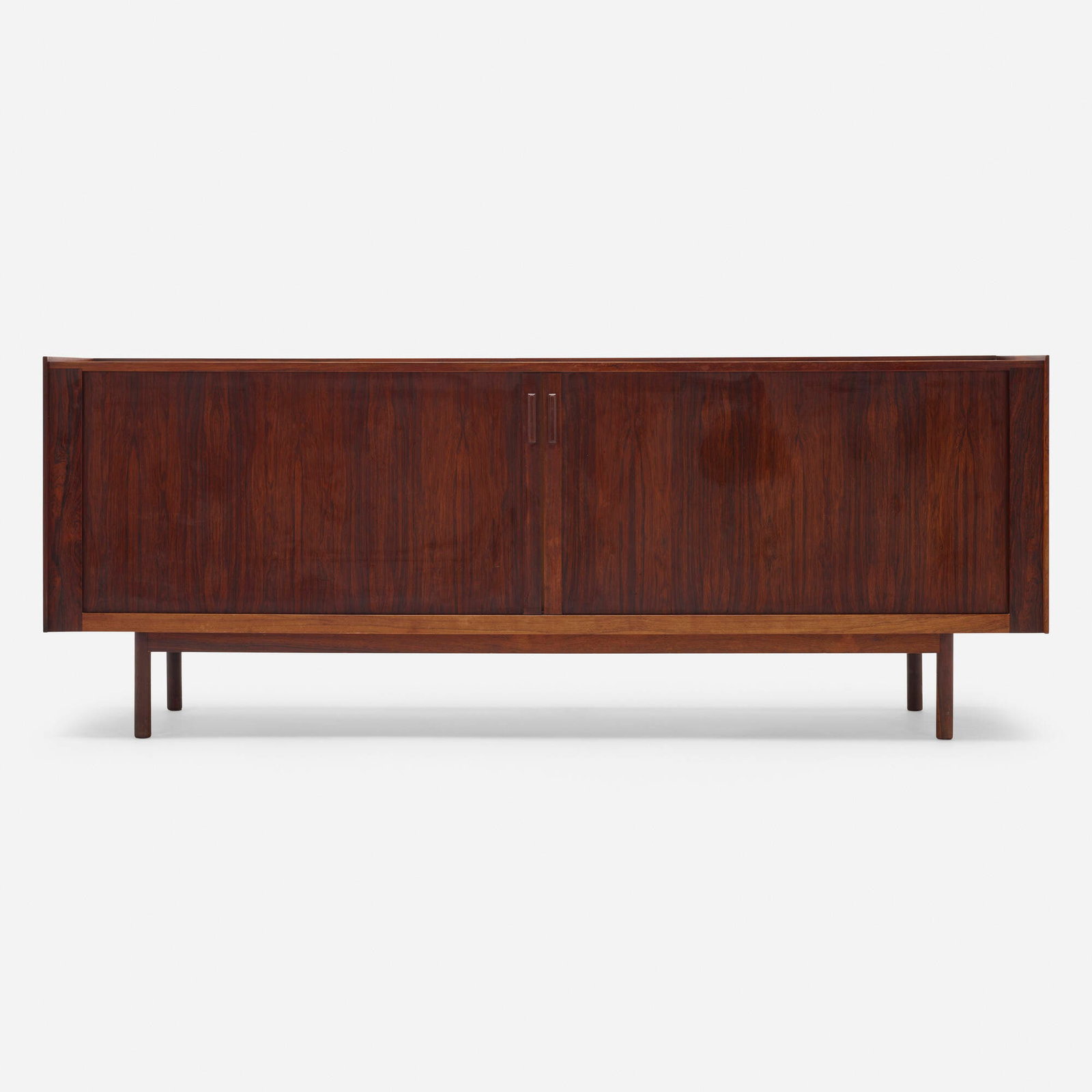 Ib Kofod-Larsen, Cabinet: Ib Kofod-Larsen Cabinet Denmark, c. 1955 rosewood 31.375 h x 81 w x 19.5 d in (80 x 206 x 50 cm) Cabinet features two tambour doors concealing four shelves and four felt-lined trays. Danish Con