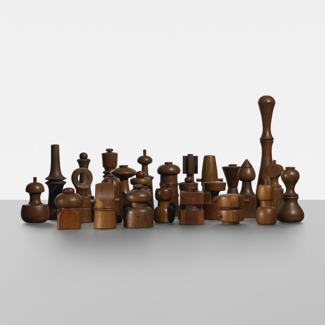 Jens Quistgaard collection of peppermills: Jens Quistgaard collection of twenty-six peppermills Dansk Designs Denmark teak 2.75 dia x 16.5 h inches Ten peppermills feature Puegot grinding mechanisms. Signed with molded manufacturer's marks to