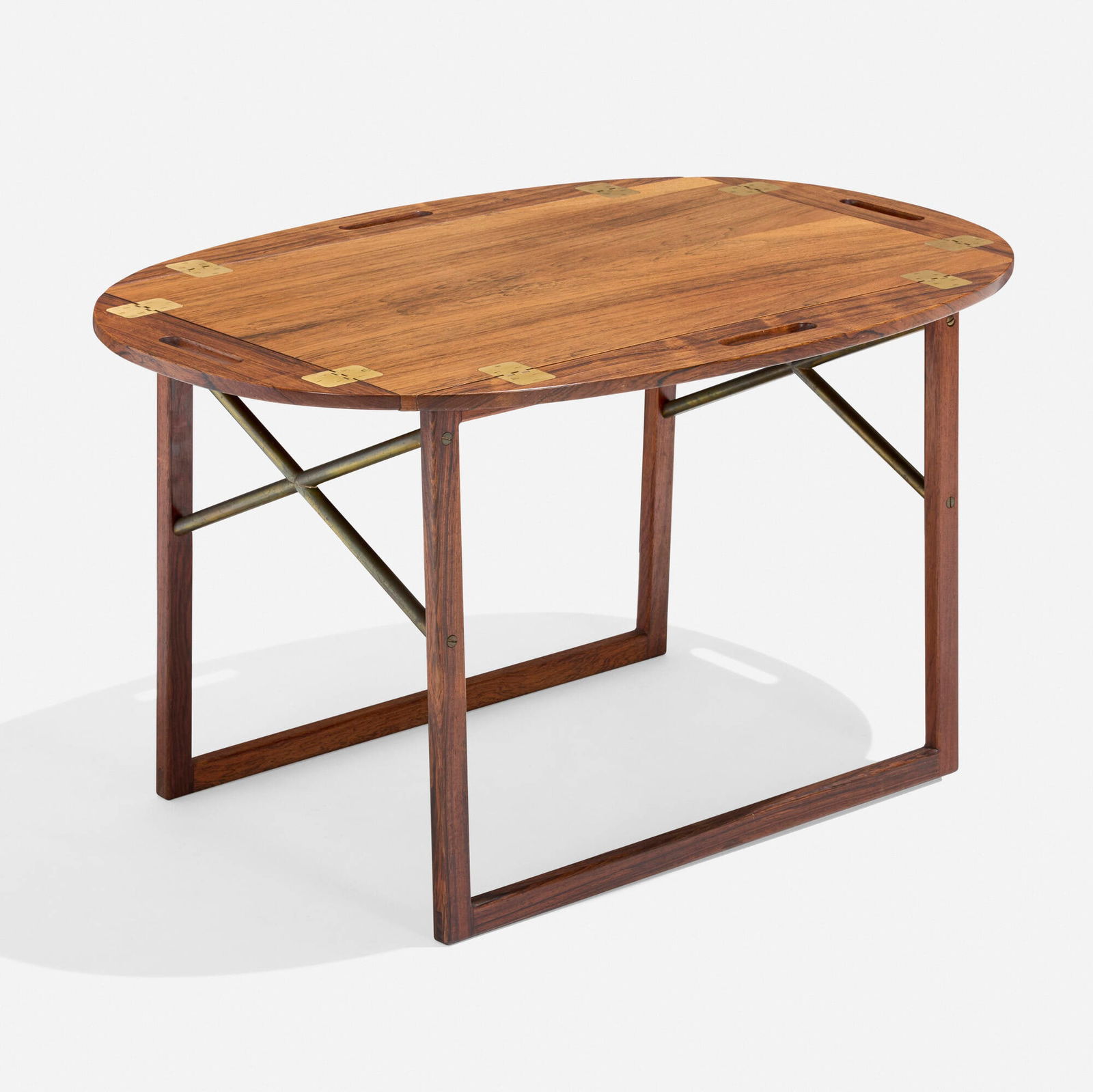 Svend Langkilde, Tray table: Svend Langkilde Tray table Denmark, c. 1960rosewood, brass 23 h x 18.5 w x 29 d in (58 x 47 x 74 cm) Table features a removable tray with folding sides. Literature: