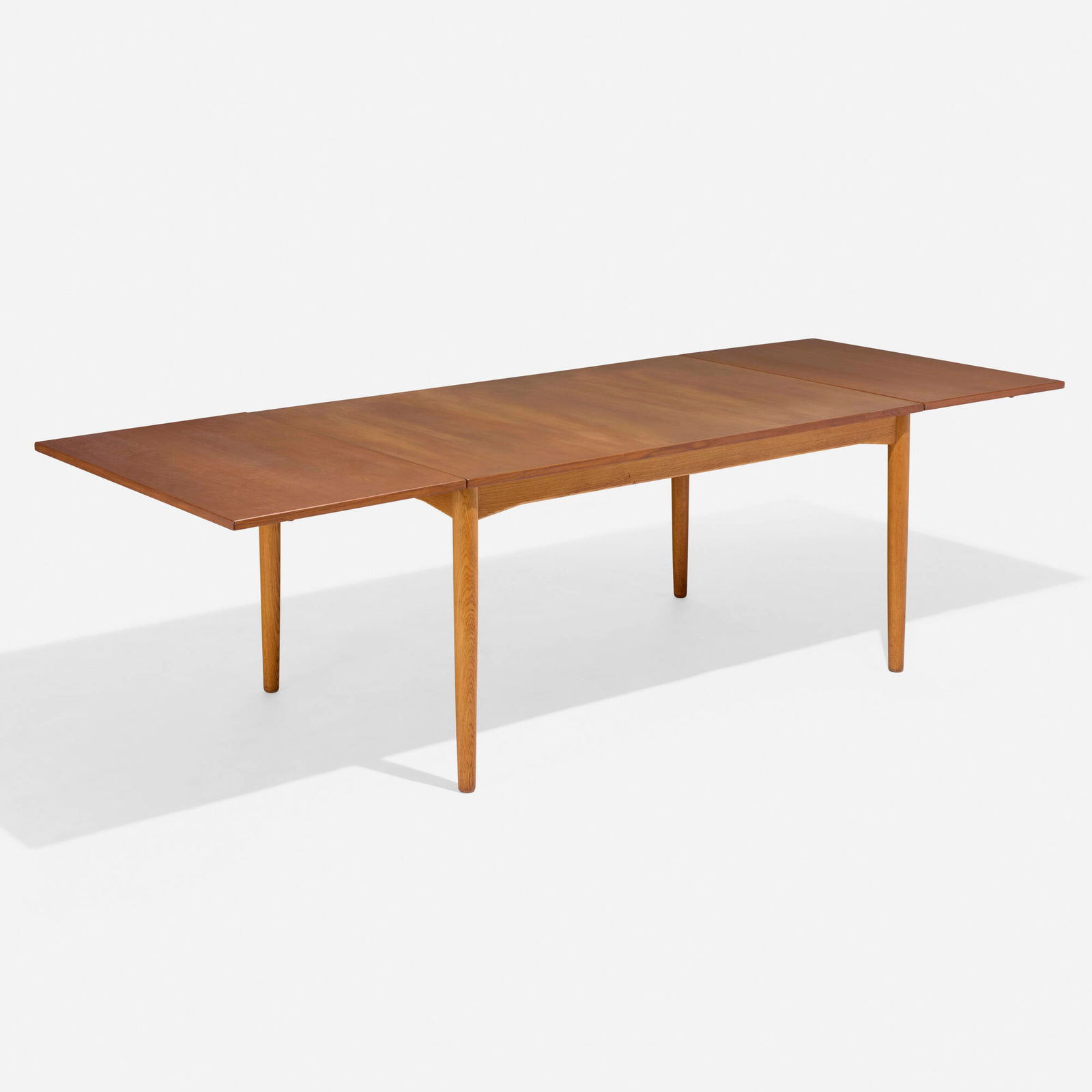 Borge Mogensen, Drop-leaf dining table: Borge Mogensen Drop-leaf dining table Karl Andersson & SonerDenmark / Sweden, c. 1955teak, oak, brass 28.375 h x 57.625 w x 36.5 d in (72 x 146 x 93 cm) Sold with two 22-inch leaves; tab