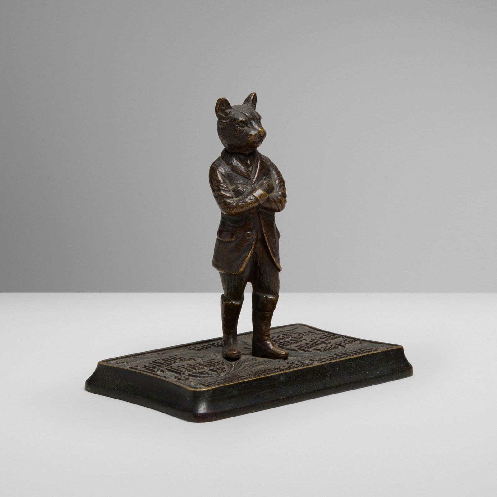 Flockton, Tompkin & Co., Gentleman Cat: Flockton, Tompkin & Co. Gentleman Cat United Kingdom, c. 1912patinated brass 4.75 h x 5 w x 3 d in (12 x 13 x 8 cm) Molded manufacturer's mark to top of base 'Flockton, Tompkin & Co. Ltd. Newh