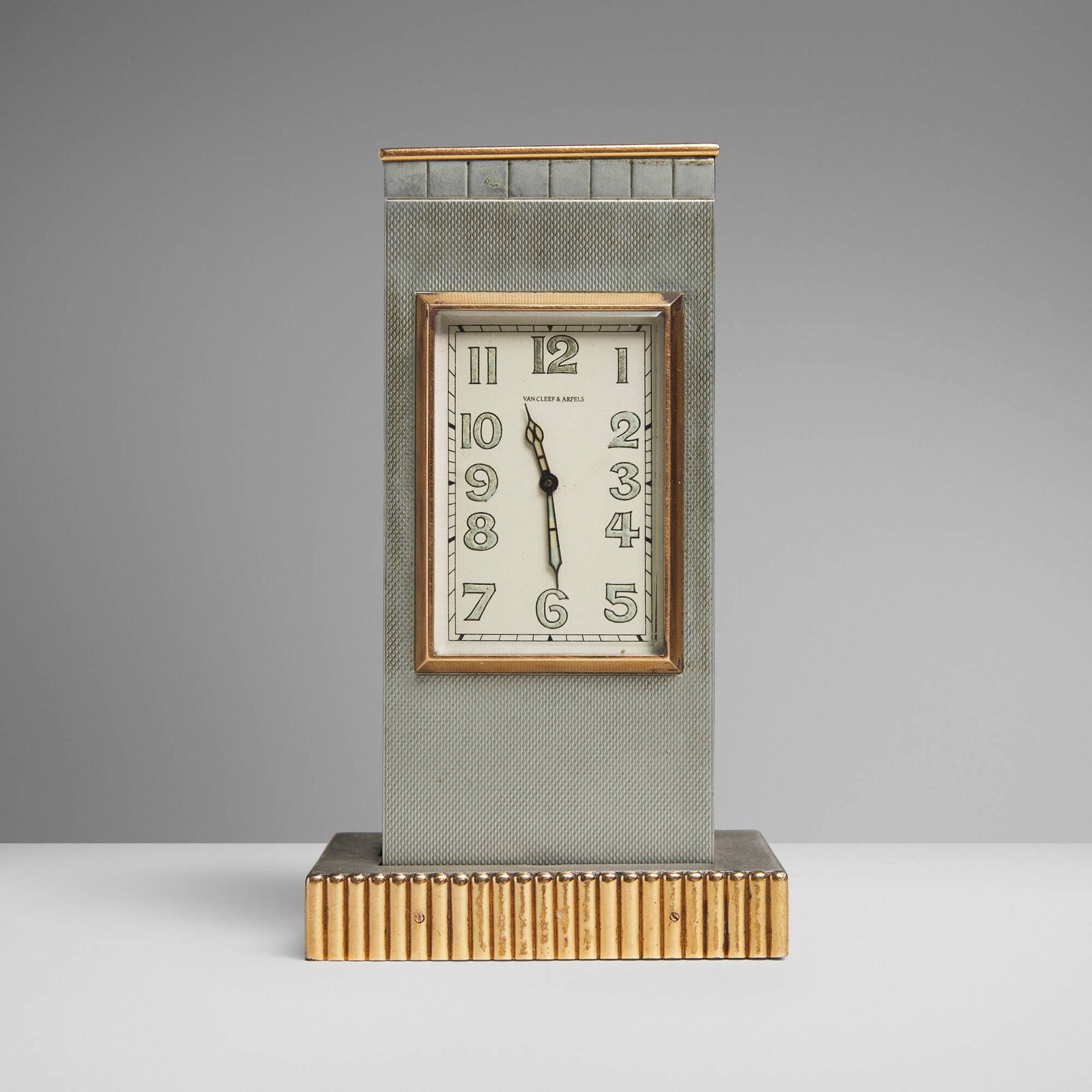 Van Cleef & Arpels, Styptor table clock and lighter: Van Cleef & Arpels Styptor table clock and lighter France, c. 1936Styptor, yellow gold, glass 5 h x 2.75 w x 2.375 d in (13 x 7 x 6 cm) Styptor is an alloy of pewter and silver used briefly du