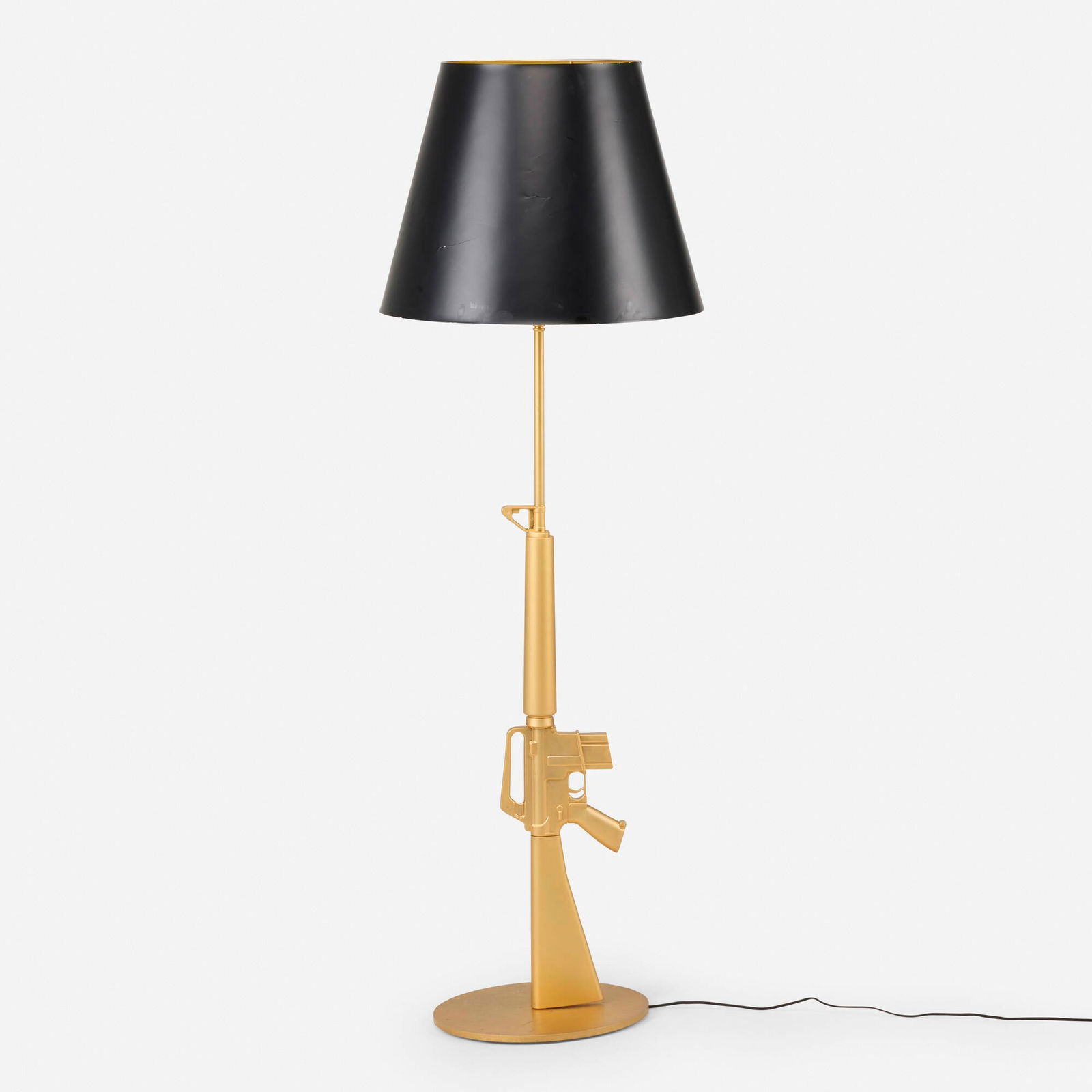 Philippe Starck, Lounge Gun floor lamp: Philippe Starck Lounge Gun floor lamp FlosFrance / Italy, 2005gilt aluminum with polymer coating, gilt steel 66.5 h x 22 dia in (169 x 56 cm) Decal manufacturer's labels to underside of