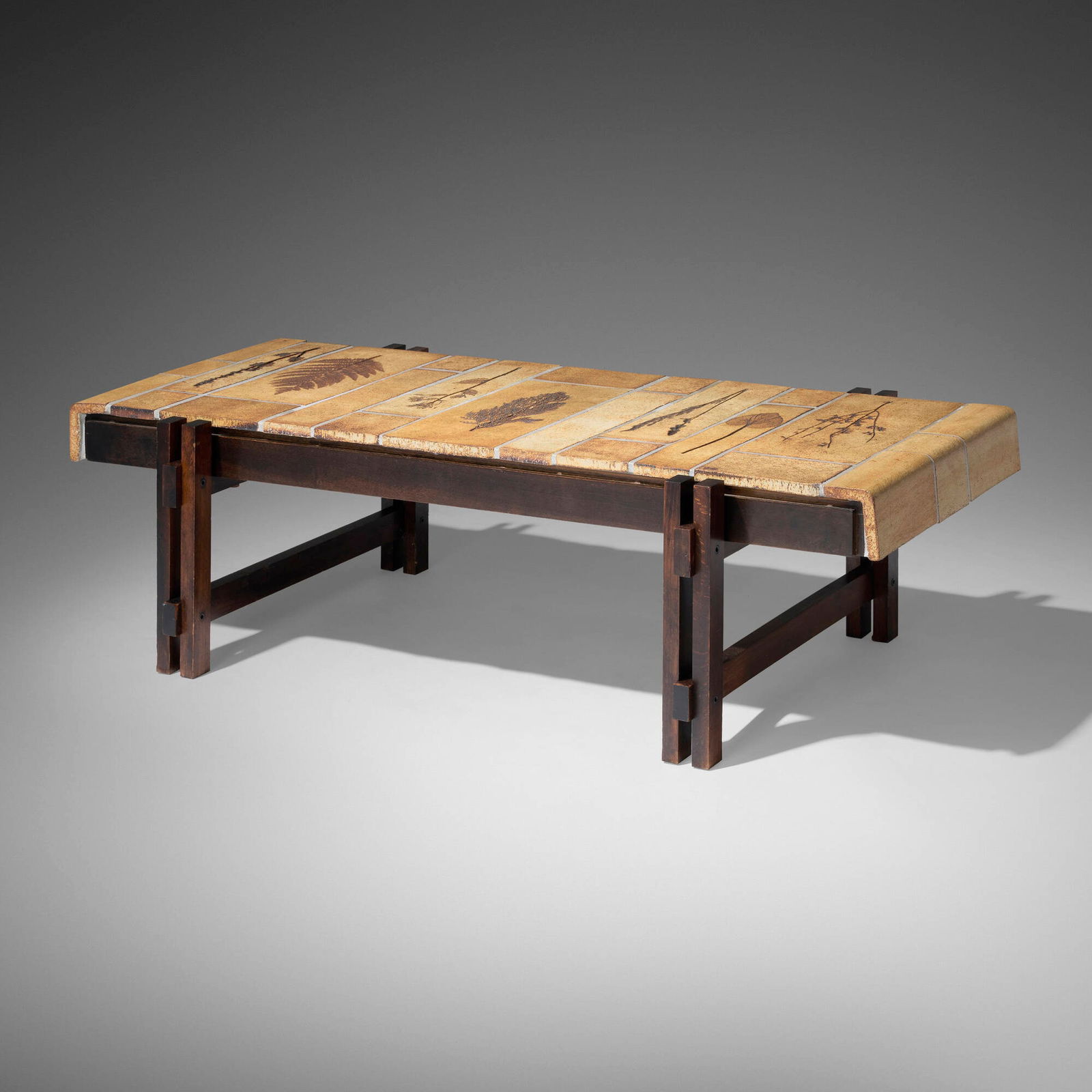 Roger Capron, Coffee table: Roger Capron Coffee table France, c. 1970glazed earthenware, stained birch 14 h x 46.5 w x 22.5 d in (36 x 118 x 57 cm) Table features seven tiles with distinct botanical decorations. Impresse
