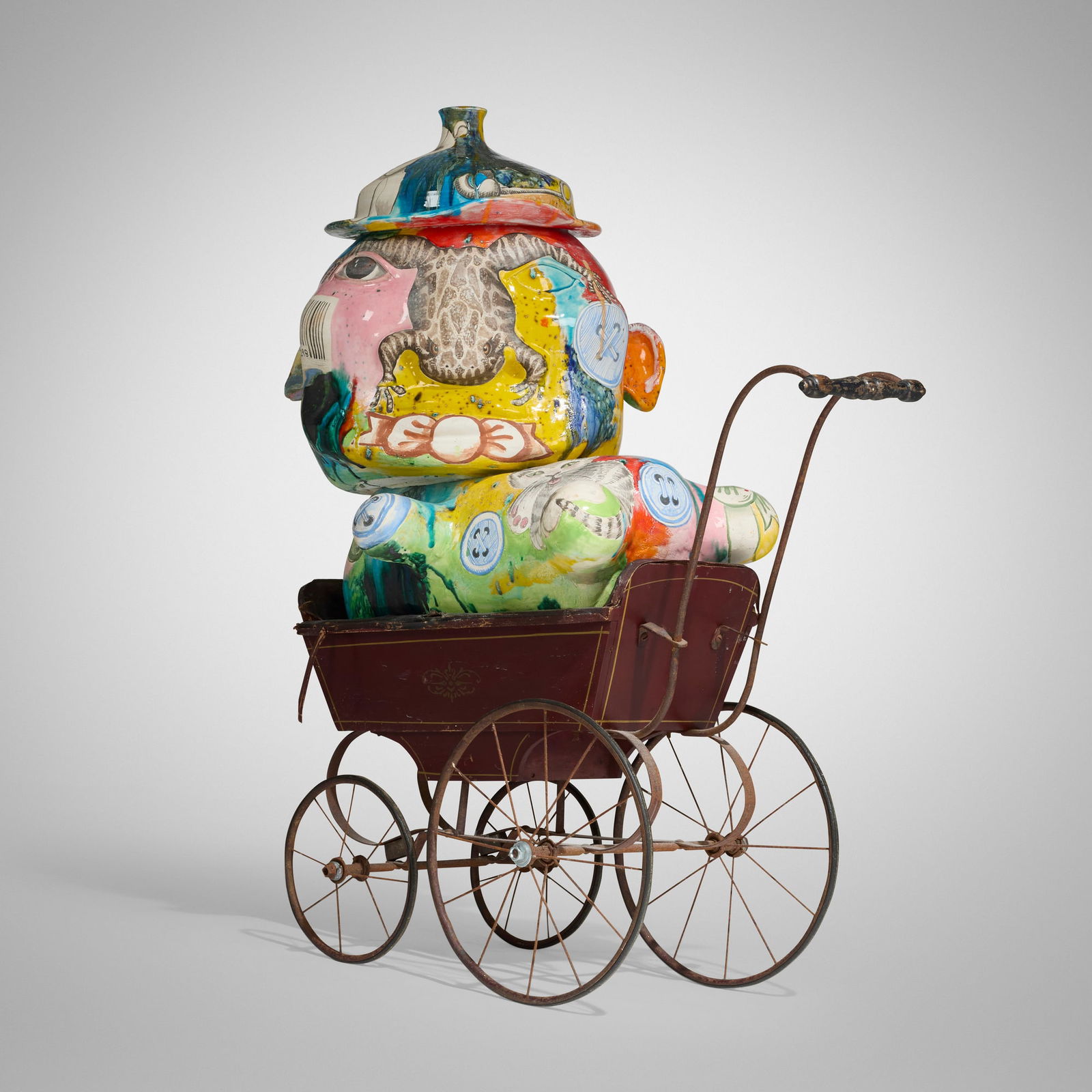 Michael Lucero, Anthromorphic Jug Form: Michael Lucero Anthromorphic Jug Form USA, c. 1993glazed and hand-painted earthenware, repurposed baby carriage 37 h x 28.5 w x 16 d in (94 x 72 x 41 cm) Signed to side of hat 'Michael Lucero'