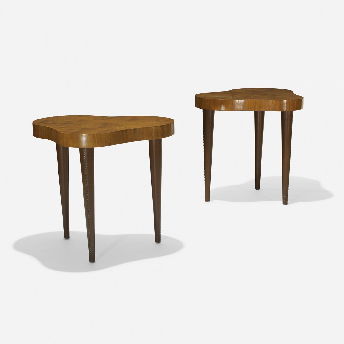 Gilbert Rohde occasional tables model 4187, pair: Gilbert Rohde occasional tables model 4187, pair Herman Miller USA, 1941 acadia burl, vinyl, brass 27 w x 22.25 d x 24 h inches Signed with applied metal manufacturer's label to underside of each exam