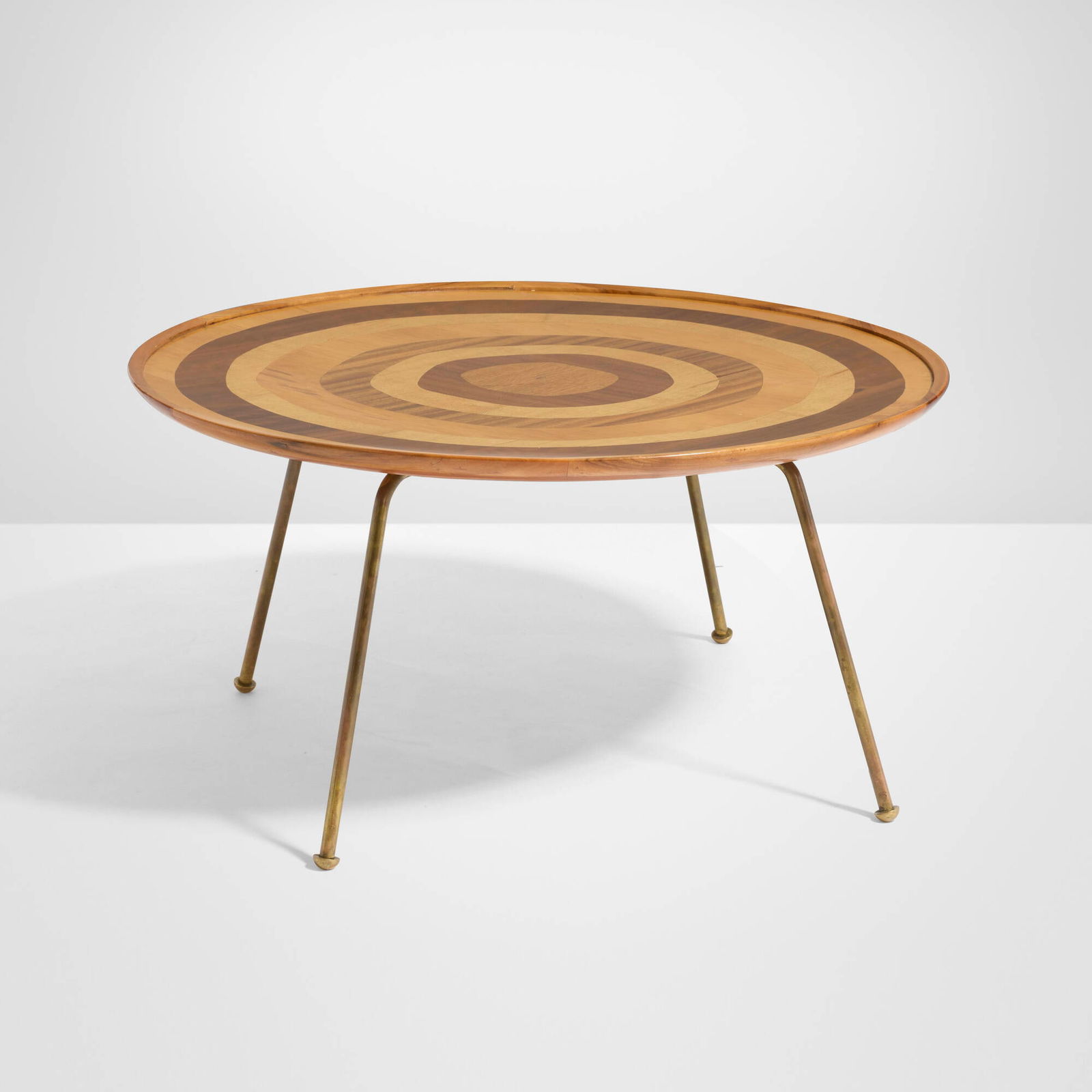 Giovanni (Nino) Zoncada, Coffee table: Giovanni (Nino) Zoncada Coffee table AltamiraItaly, c. 1955mahogany, various wood veneer, brass 17.75 h x 35.25 dia in (45 x 90 cm) Metal manufacturer's label to underside 'Made Expressl