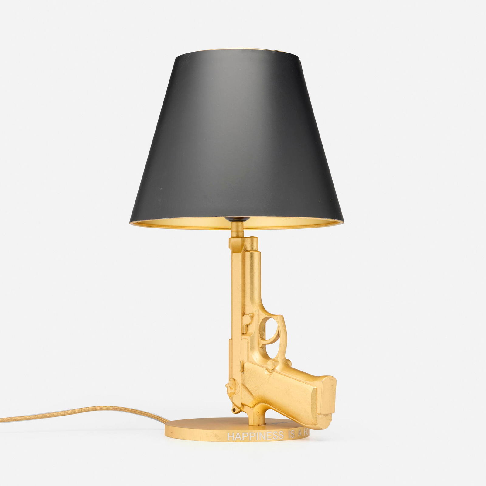 Philippe Starck, Prototype Golden Gun table lamp: Philippe Starck Prototype Golden Gun table lamp FlosFrance / Italy, 2005gold leaf over aluminum, paper shade 16.75 h x 8 w x 9.25 d in (43 x 20 x 23 cm) The Gun Lamp collection was intro