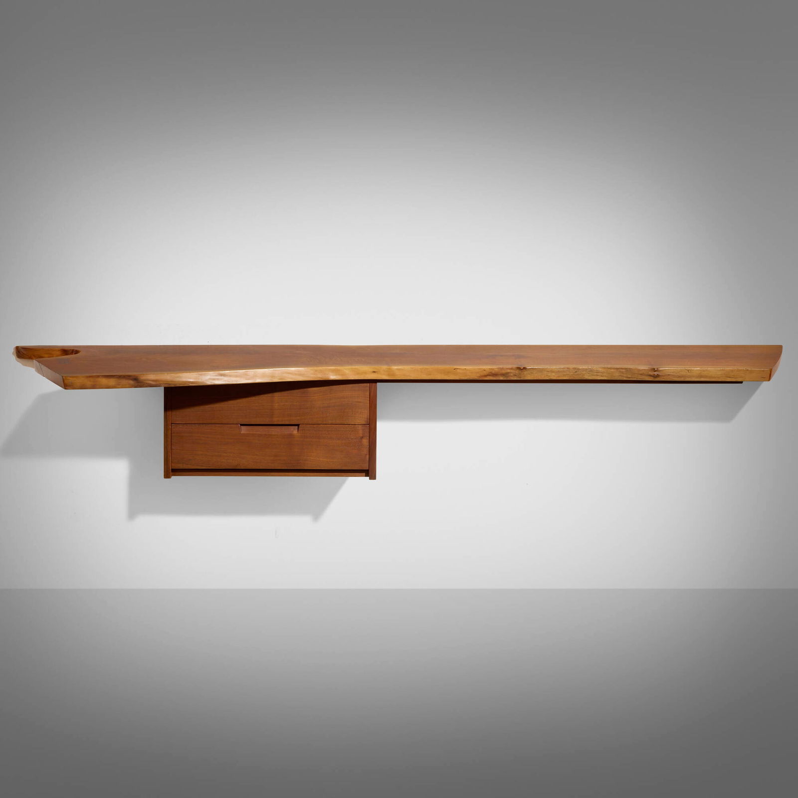 Mira Nakashima, Hanging Wall Shelf: Mira Nakashima Hanging Wall Shelf Nakashima StudioUSA, 1995American black walnut, rosewood 11.5 h x 79 w x 21 d in (29 x 201 x 53 cm) Wall shelf features a single slab top with free edge
