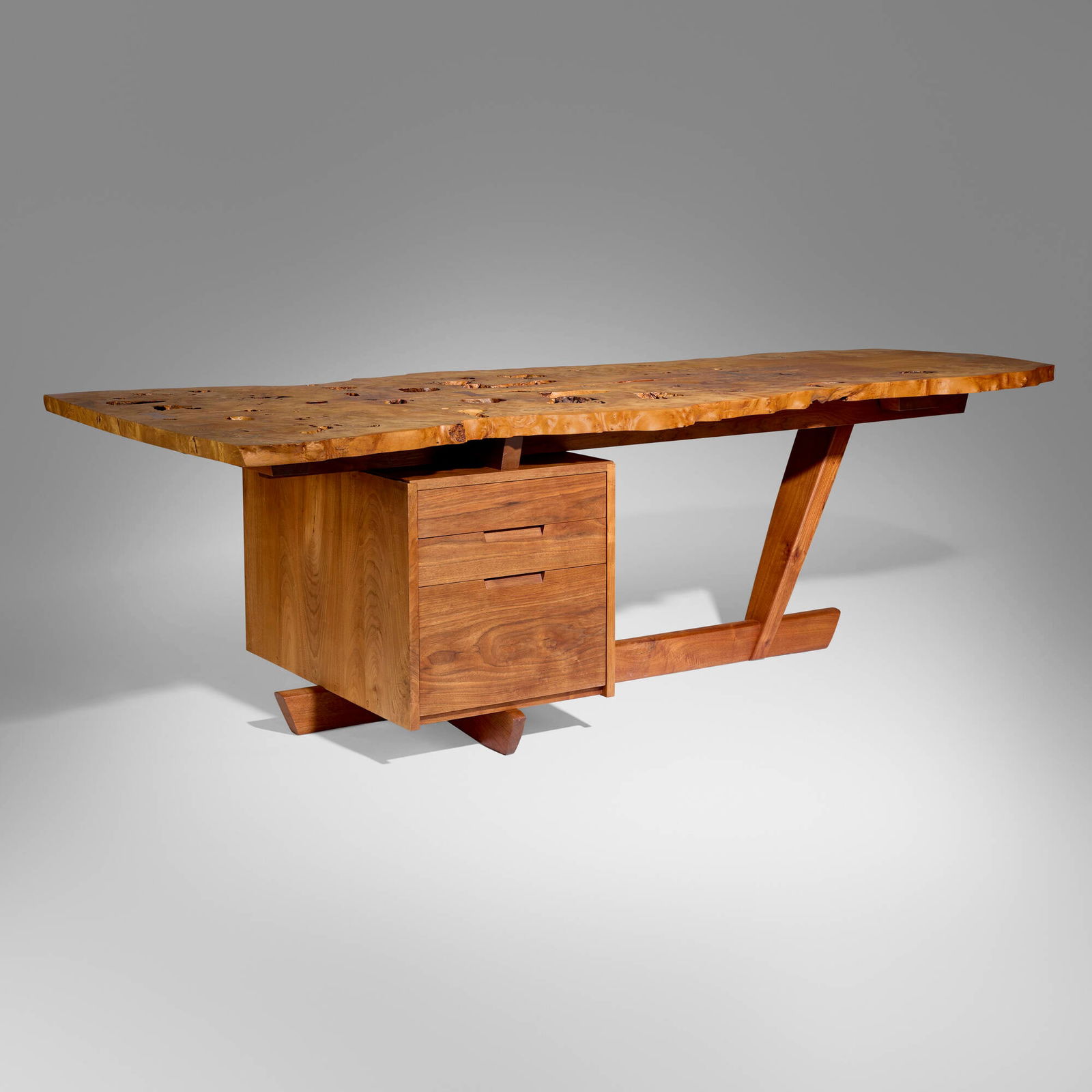 Mira Nakashima, Custom desk: Mira Nakashima Custom desk Nakashima StudioUSA, 1998Carpathian elm burl, American black walnut 29.125 h x 96 w x 48 d in (74 x 244 x 122 cm) This special desk features an impressive book