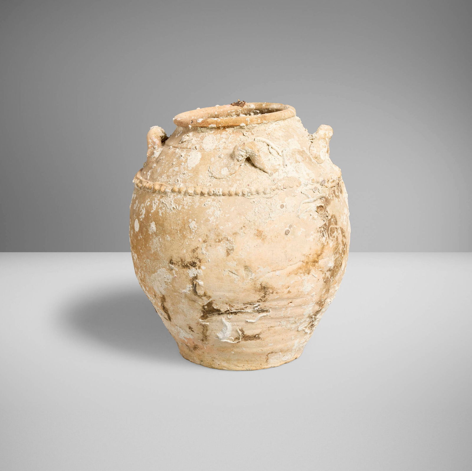 Chinese, Sea-encrusted amphora: Chinese Sea-encrusted amphora Yuan dynasty (13th-14th century) or laterstoneware 12.5 h x 10.5 dia in (32 x 27 cm) Sold with base. Provenance: Axel Vervoordt | Collecti