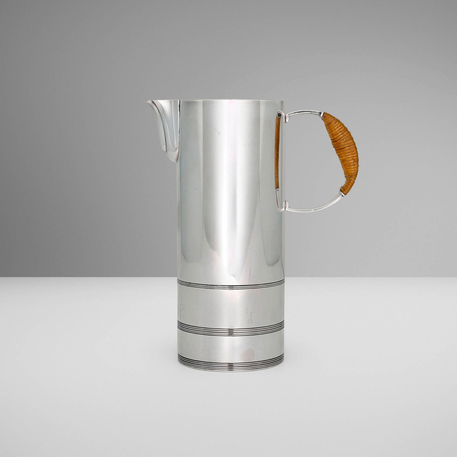Lurelle Guild, Cocktail pitcher: Lurelle Guild Cocktail pitcher International Silver CompanyUSA, c. 1940silver-plated metal, rattan 8.875 h x 7.25 w x 3.625 d in (23 x 18 x 9 cm) Impressed manufacturer's mark and number