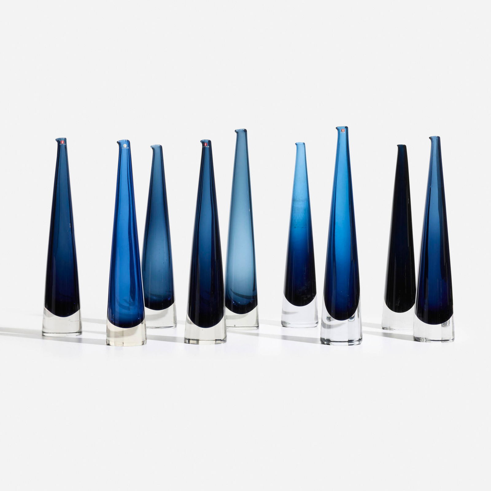 Timo Sarpaneva, Jaapuikko decanters, set of nine: Timo Sarpaneva Jaapuikko decanters, set of nine IittalaFinland, 1958glass 16 h x 3.125 dia in (41 x 8 cm) Etched signature to underside of seven examples 'Timo Sarpaneva iittala'. Decal
