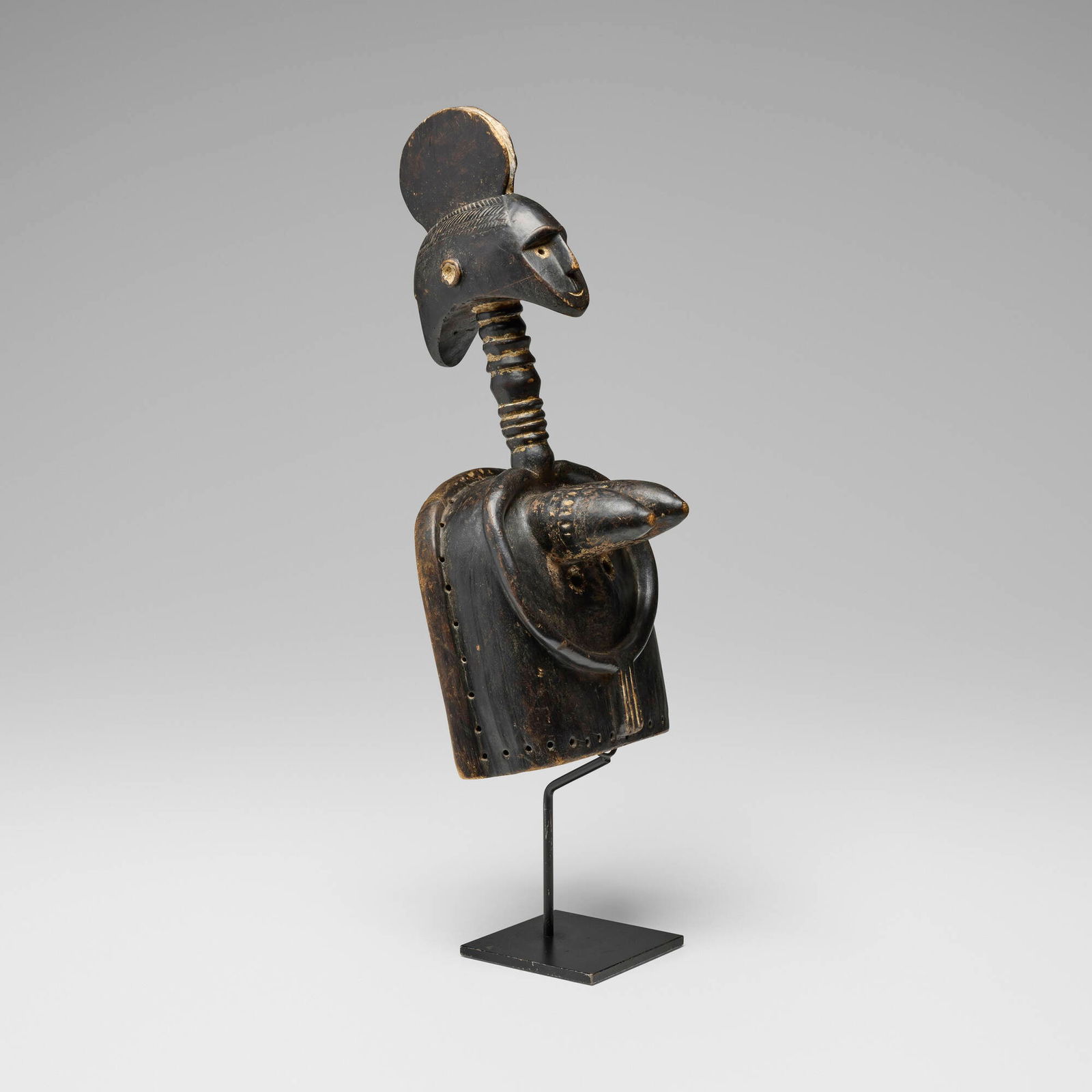 Senufo, Degele mask with female figure: Senufo Degele mask with female figure Cote d'Ivoire, 20th centurycarved and painted wood 23.75 h x 10 w x 8.5 d in (60 x 25 x 22 cm) Sold with stand. Provenance: Collec