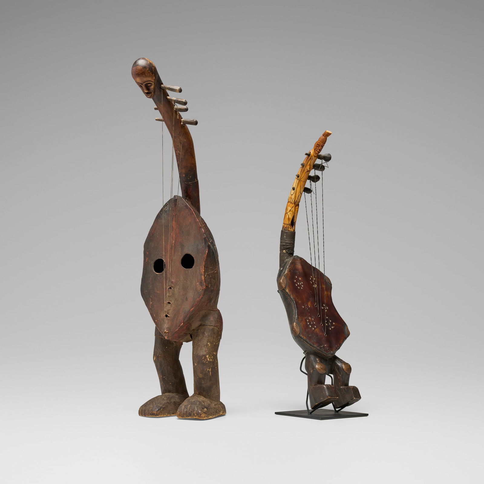 Ngbaka and Mangbetu, Figural harps, set of two: Ngbaka and Mangbetu Figural harps, set of two Democratic Republic of the Congo, 20th centurycarved wood, leather, copper, bone, cord 29.5 h x 7 w x 9 d in (75 x 18 x 23 cm) 24.5 h x 6.5 w x 6 d in